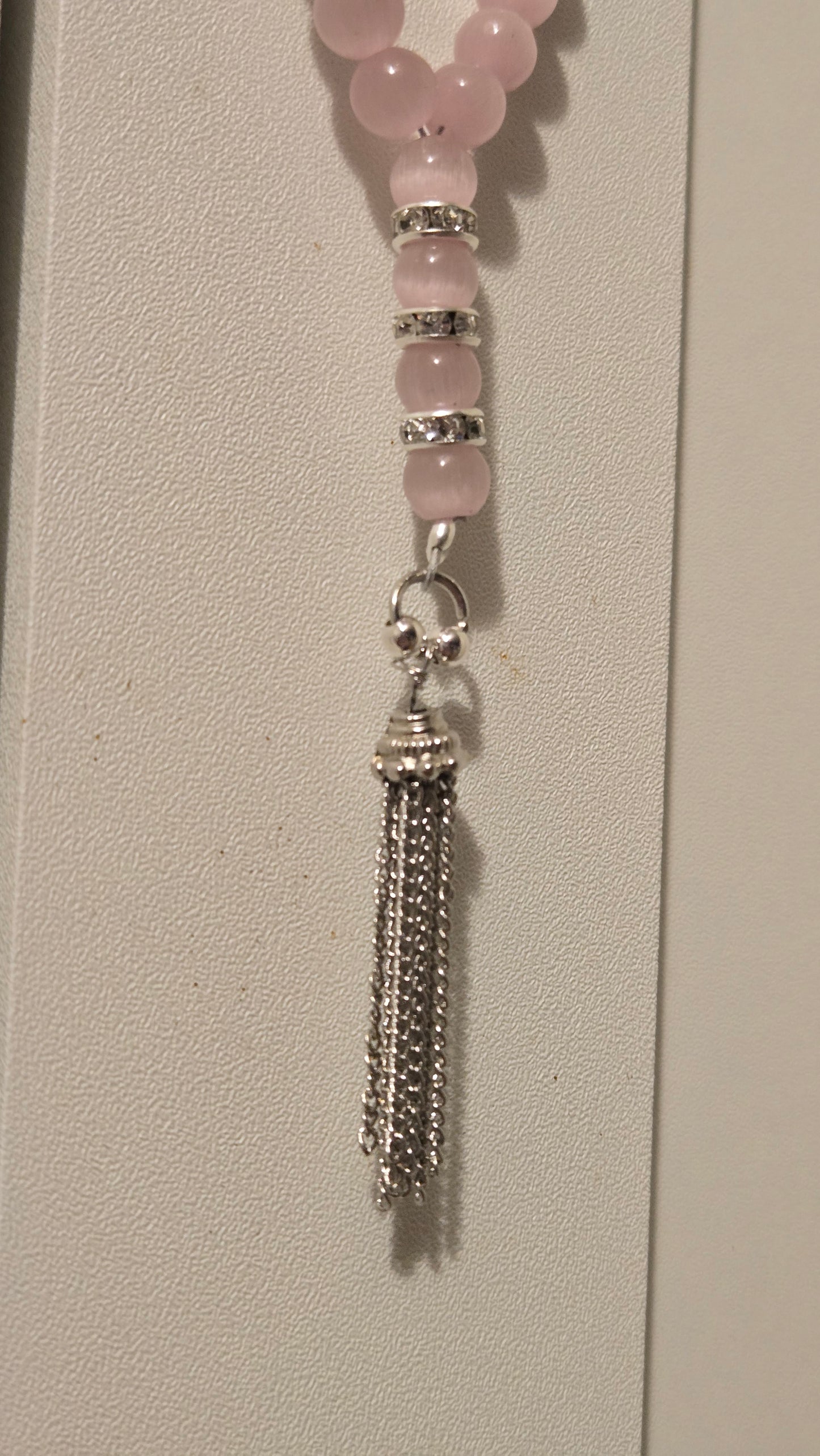 Detailed view of the silver-tone accents and the tassel knot of the LuluTouch tasbih