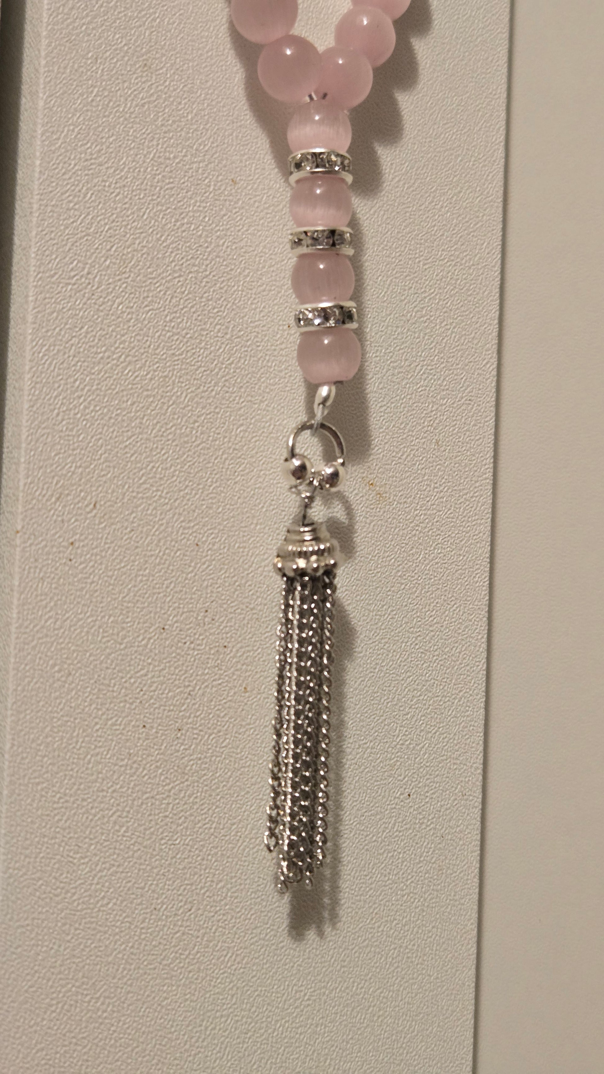 Detailed view of the silver-tone accents and the tassel knot of the LuluTouch tasbih