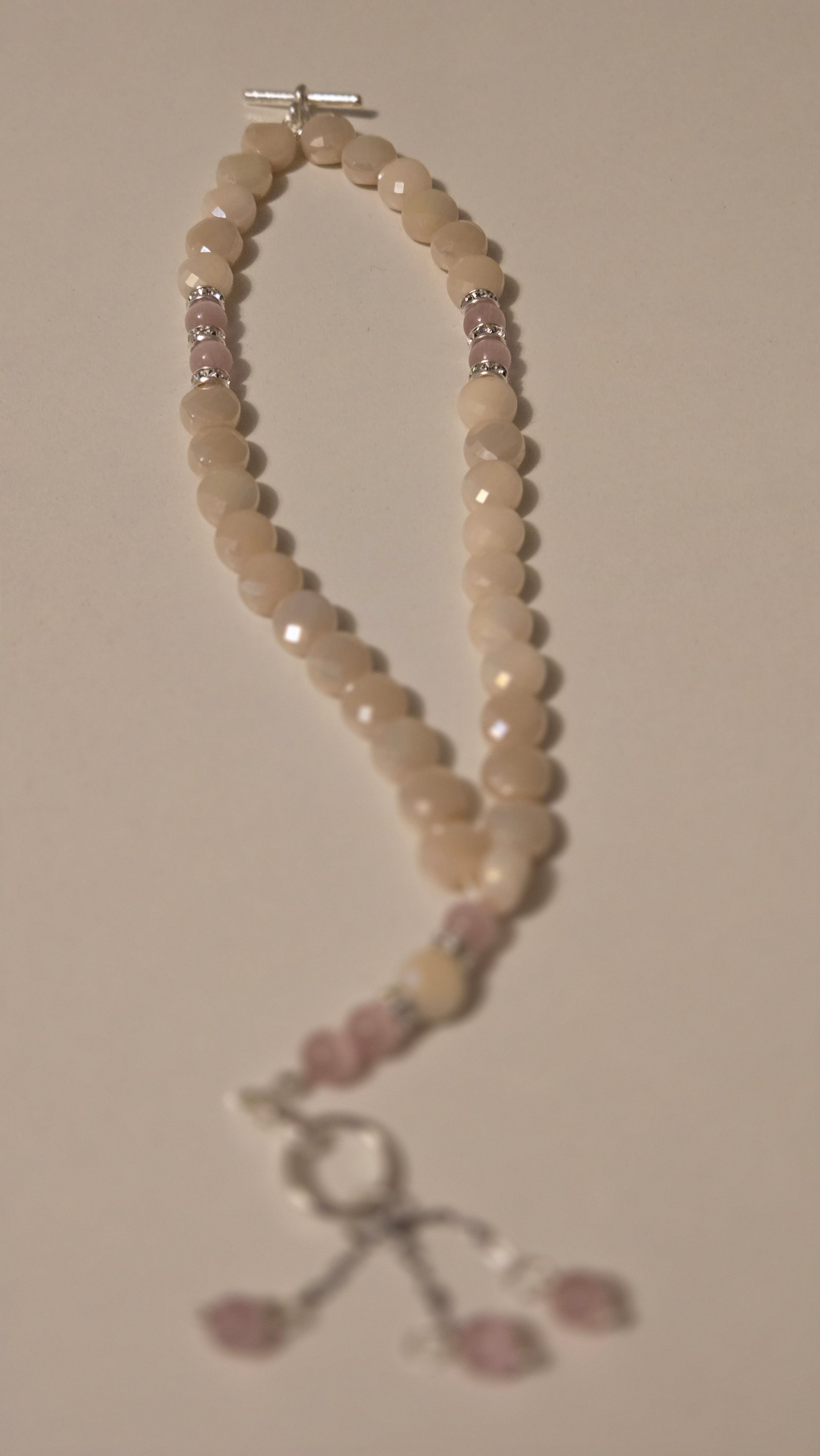 Multiple angles of the Rose Light Tasbih beads in natural light