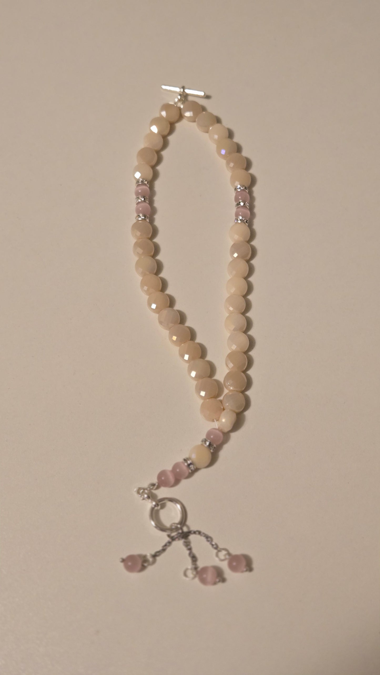 Detailed view of the rose quartz texture in the Rose Light Tasbih