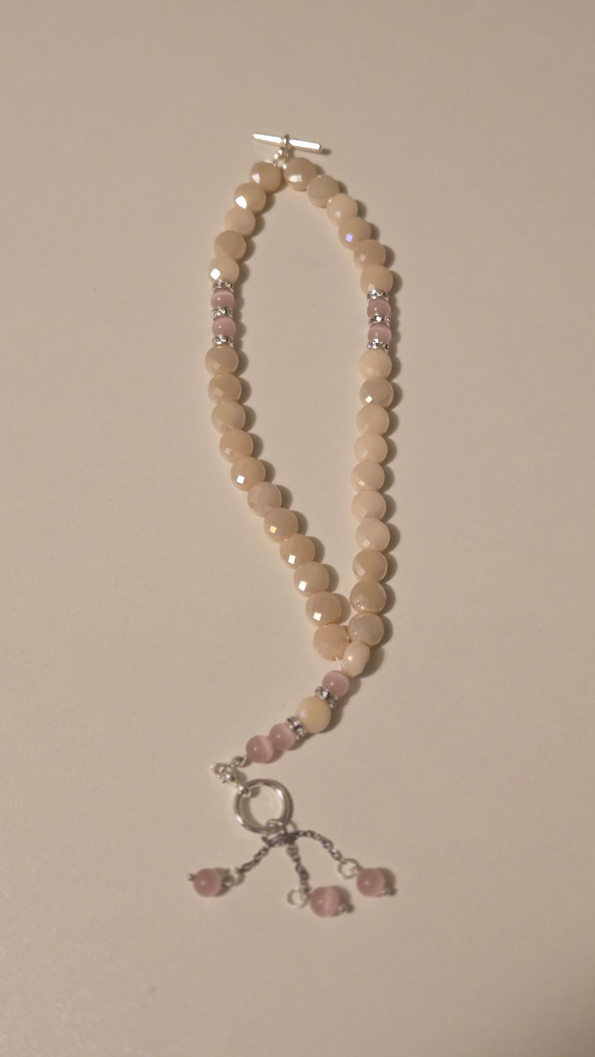 Detailed view of the rose quartz texture in the Rose Light Tasbih