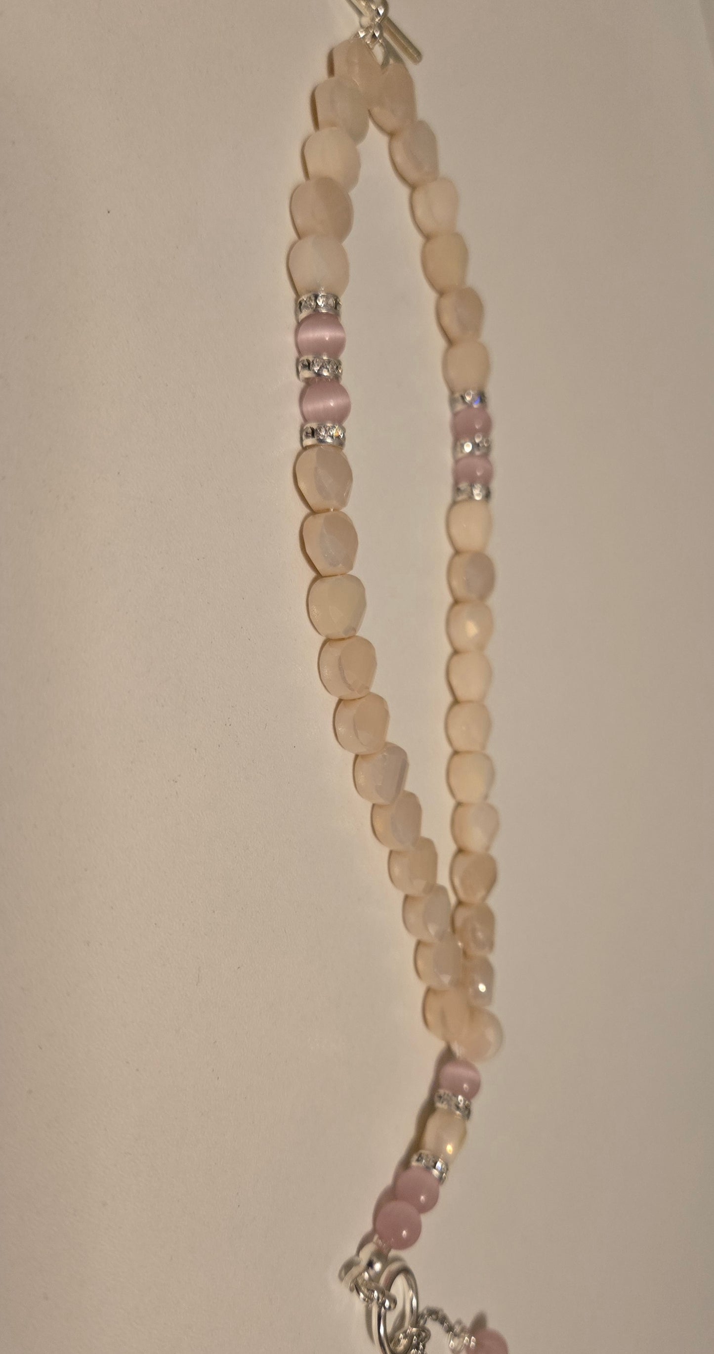 Rose Light Tasbih elegantly displayed on a wooden surface
