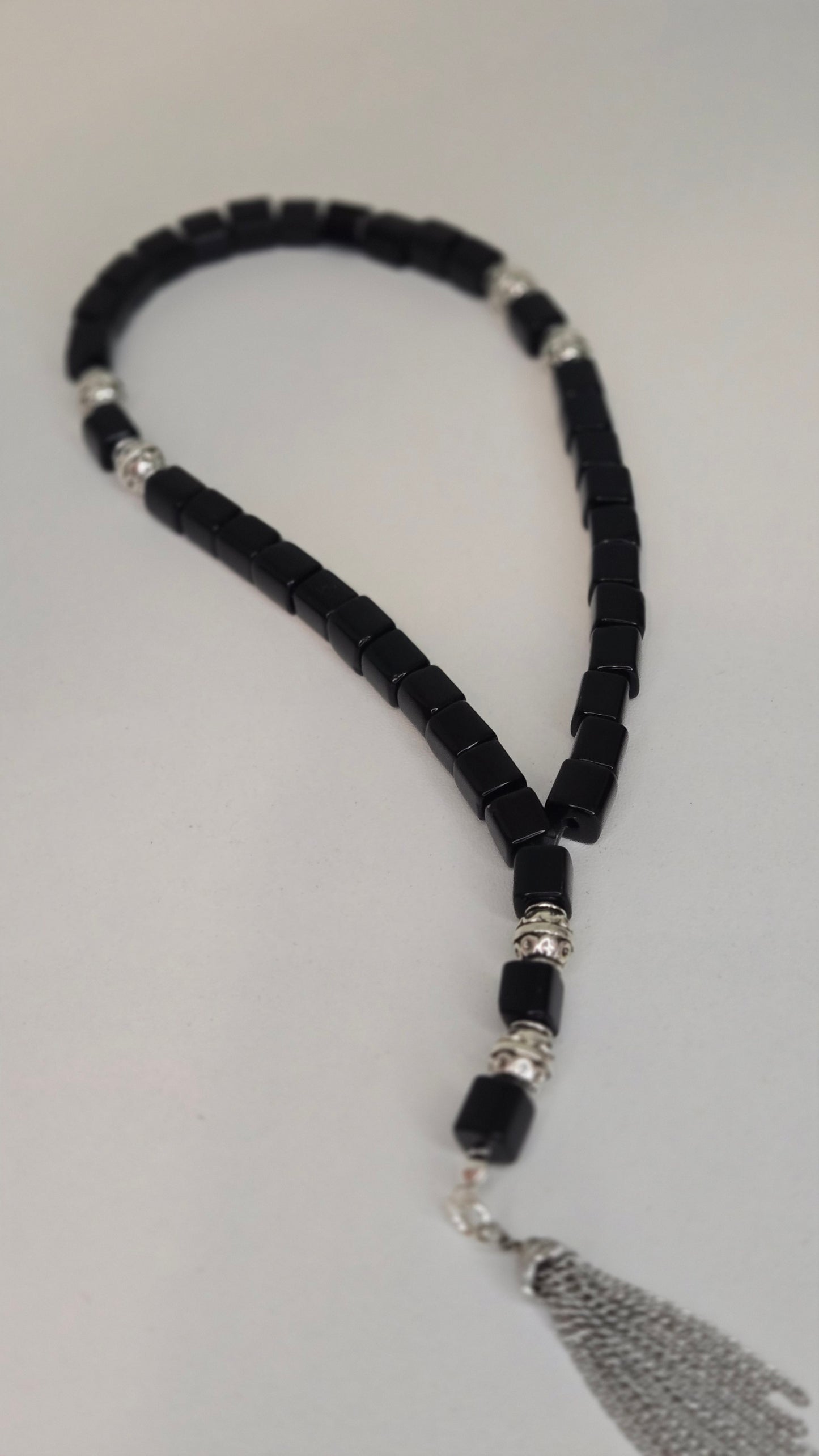 Midnight Prestige Tasbih elegantly displayed with natural lighting