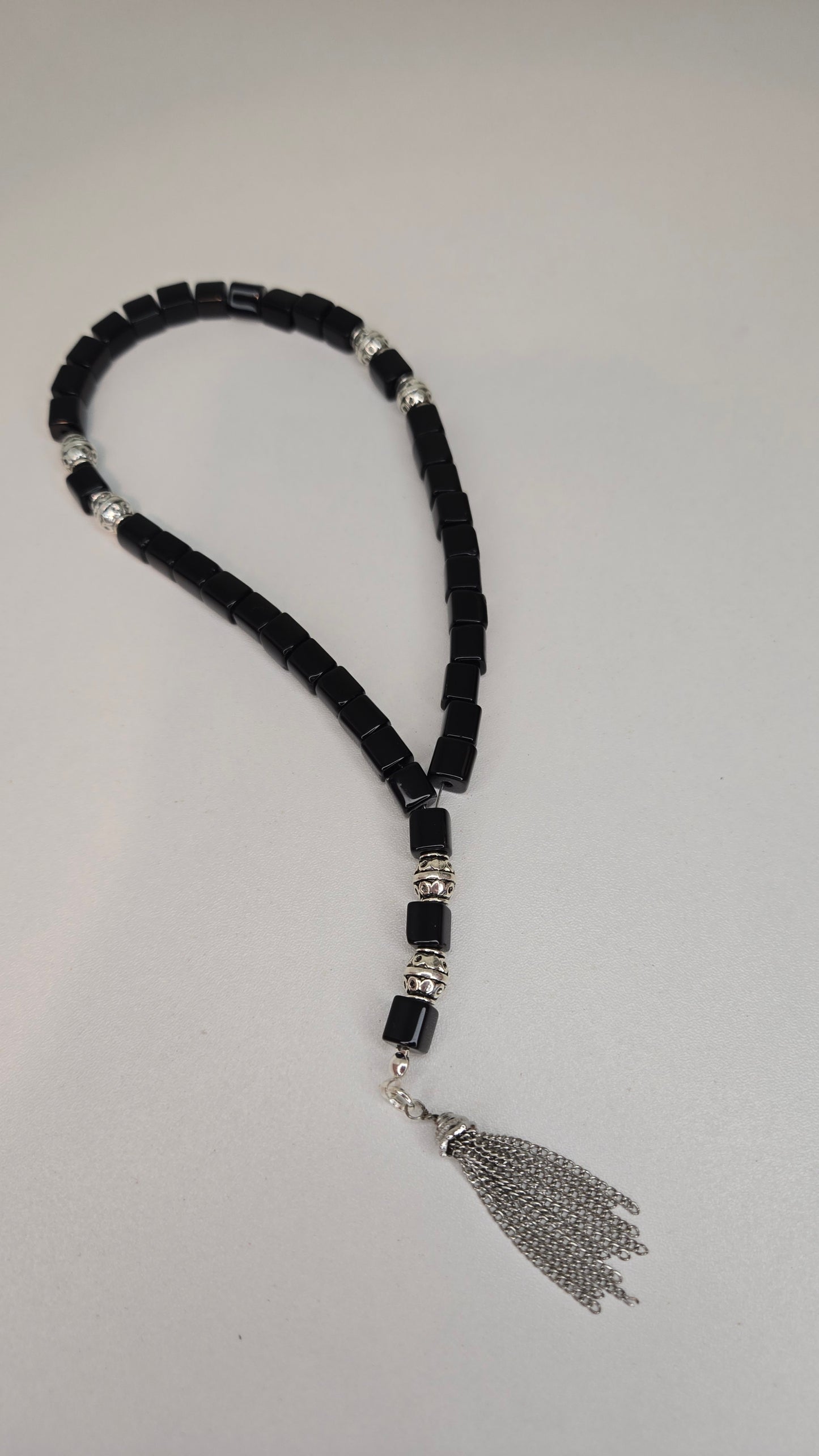 User holding Midnight Prestige Tasbih during meditation