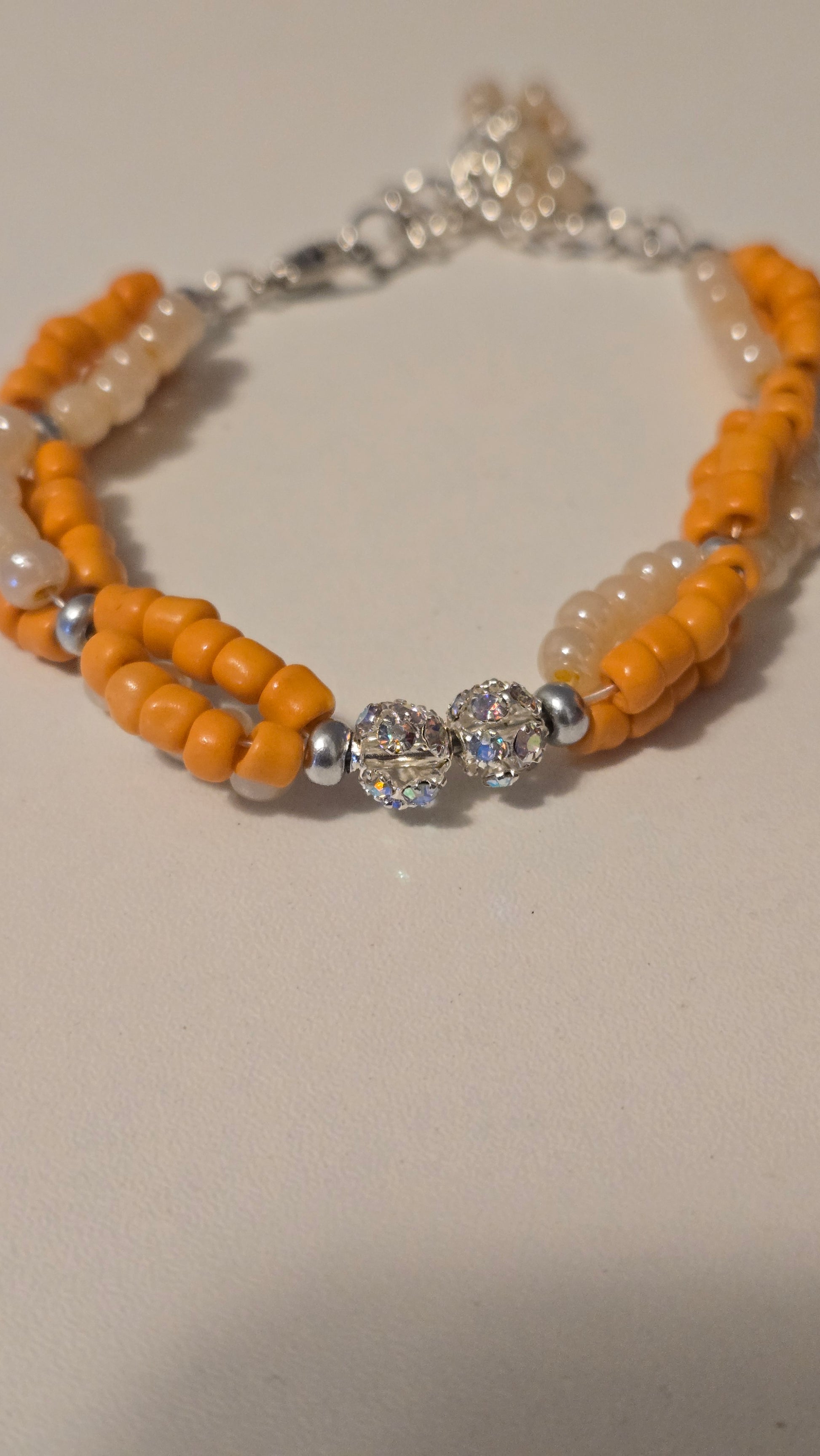 Elegant Coral Sun Bracelet lying flat, highlighting its cheerful colors and unique design.