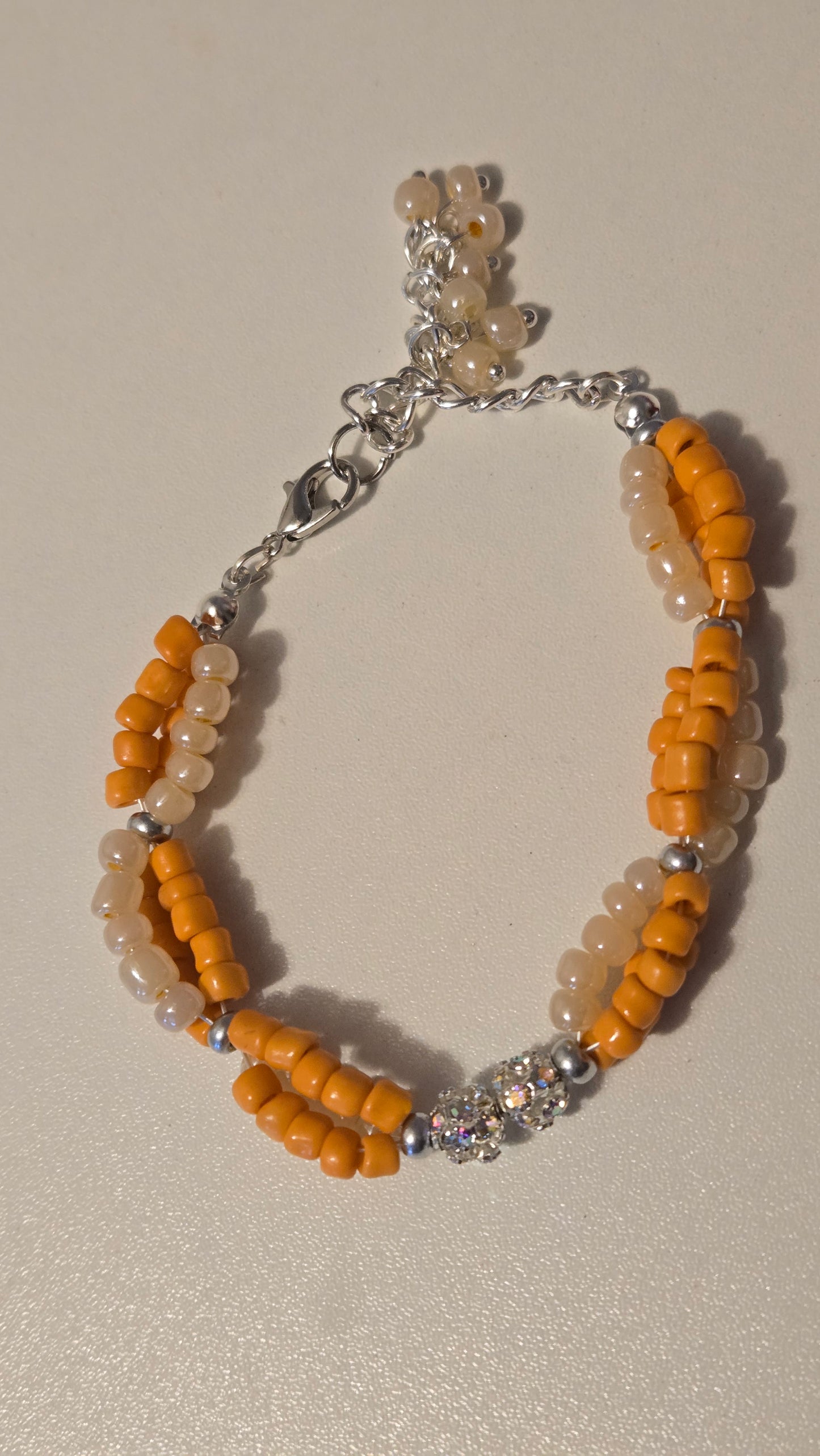 Detail shot of the secure lobster clasp on the Coral Sun Beaded Bracelet.