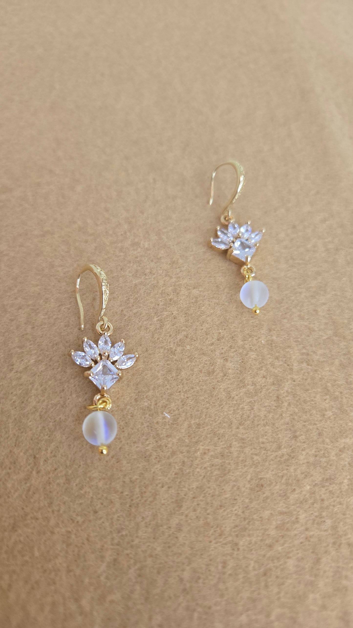 Sparkling flower earrings on a soft, elegant background