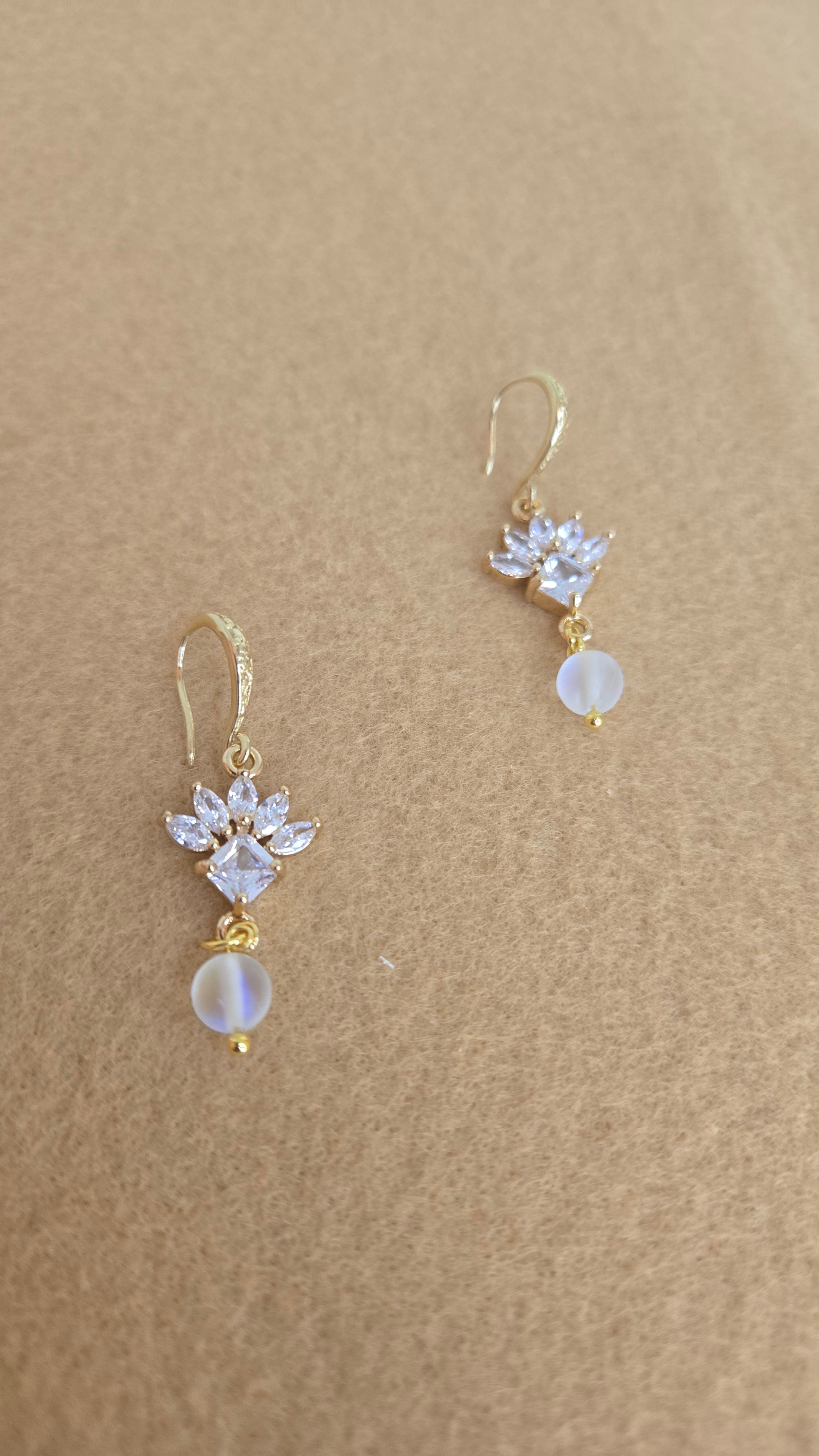 Sparkling flower earrings on a soft, elegant background