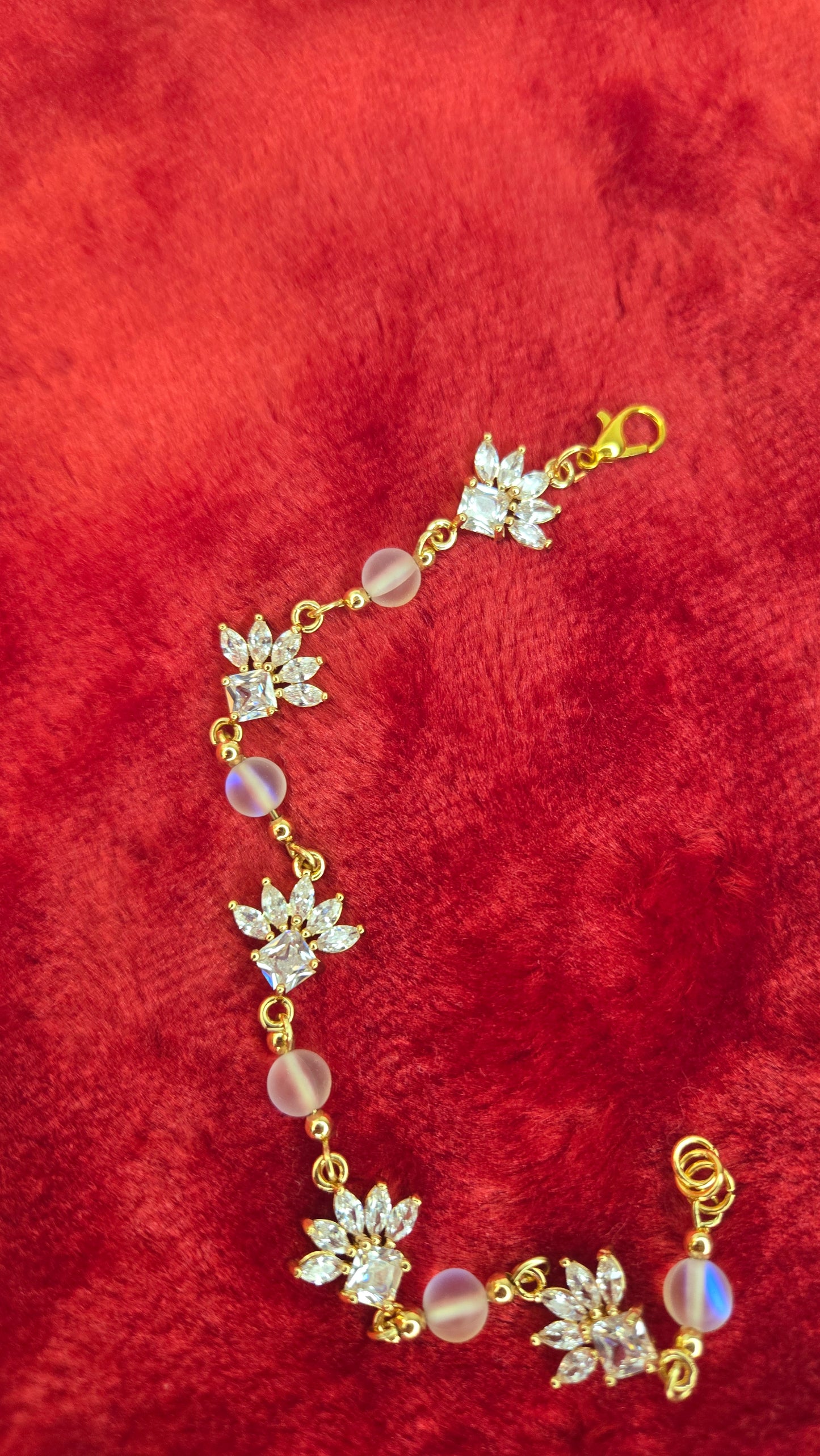 The Crystal Blossom Bracelet displayed beautifully on a delicate jewelry stand