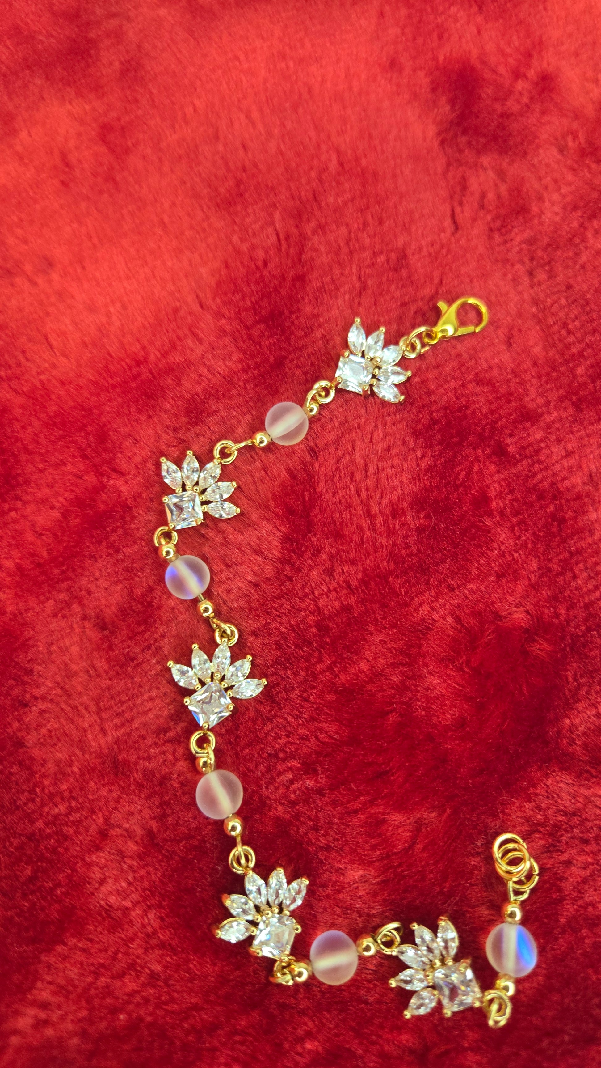 The Crystal Blossom Bracelet displayed beautifully on a delicate jewelry stand