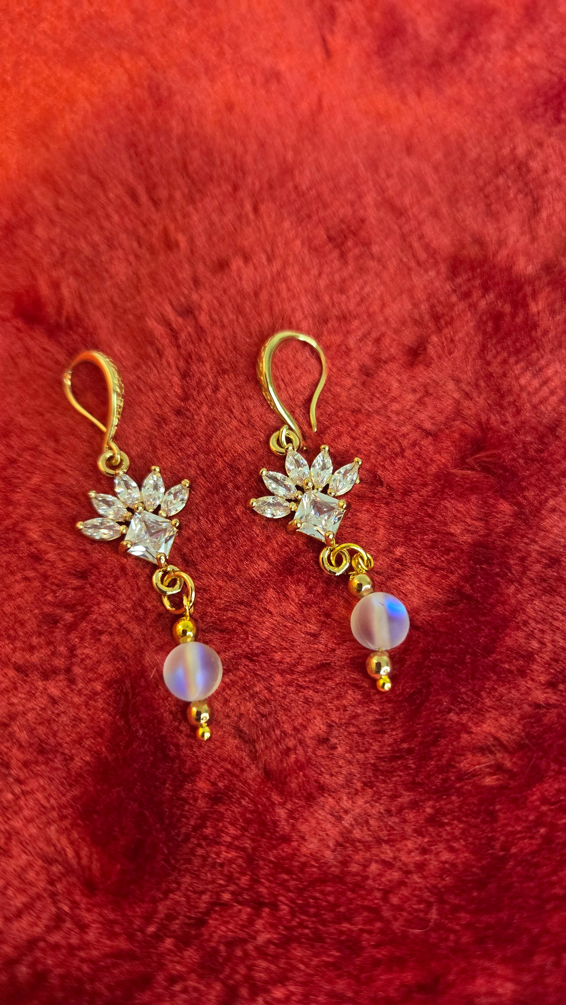 Close-up of handmade Golden Bloom Earrings showing delicate golden petals and texture.