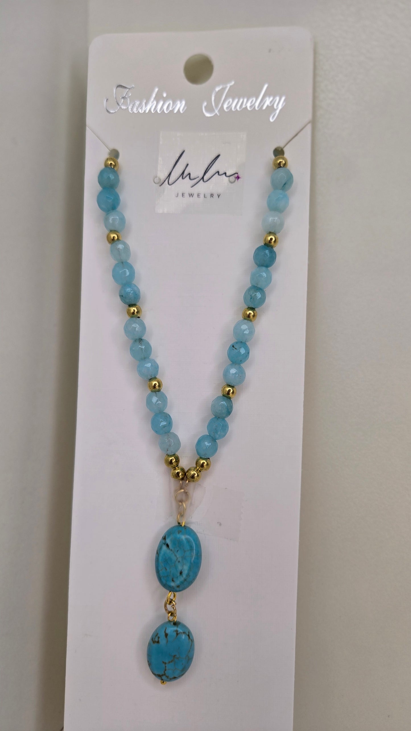 Model wearing LuluTouch elegant blue quartz necklace, perfect for versatile styling
