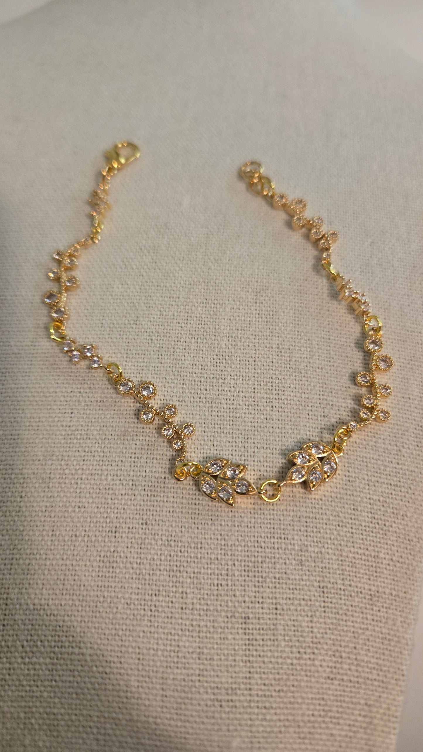 Close-up of Golden Flora Handmade Bracelet on a model's wrist, showcasing delicate floral details.