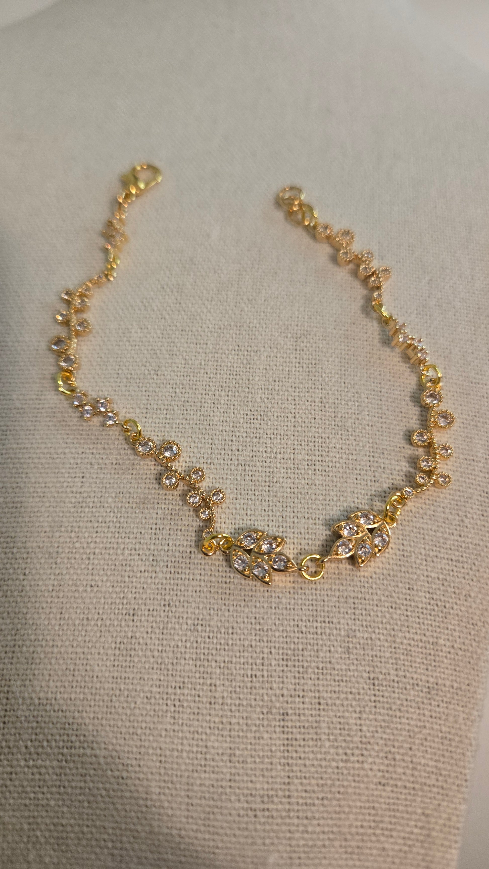 Close-up of Golden Flora Handmade Bracelet on a model's wrist, showcasing delicate floral details.
