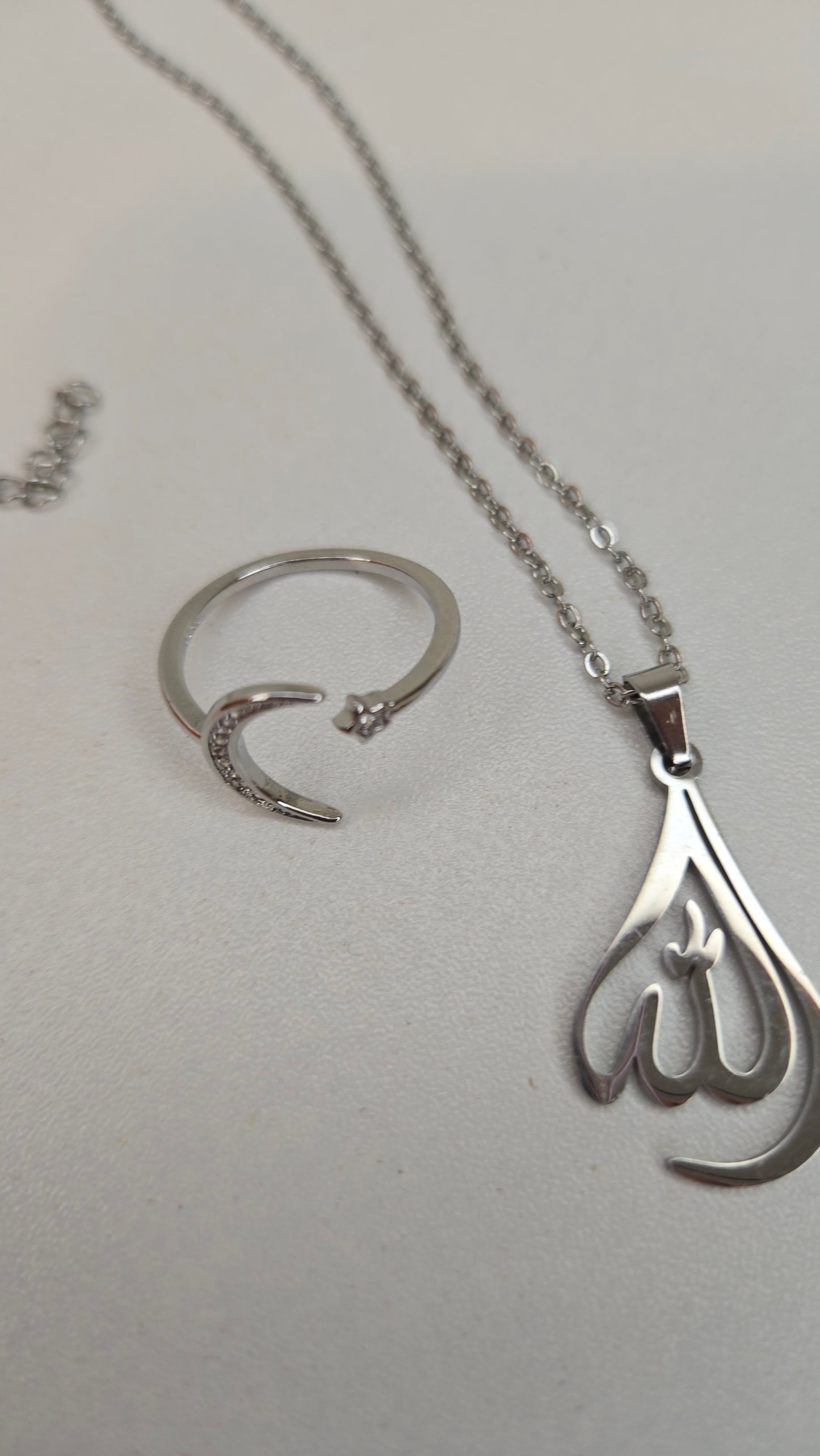 Close-up of Allah pendant showing intricate silver design and chain