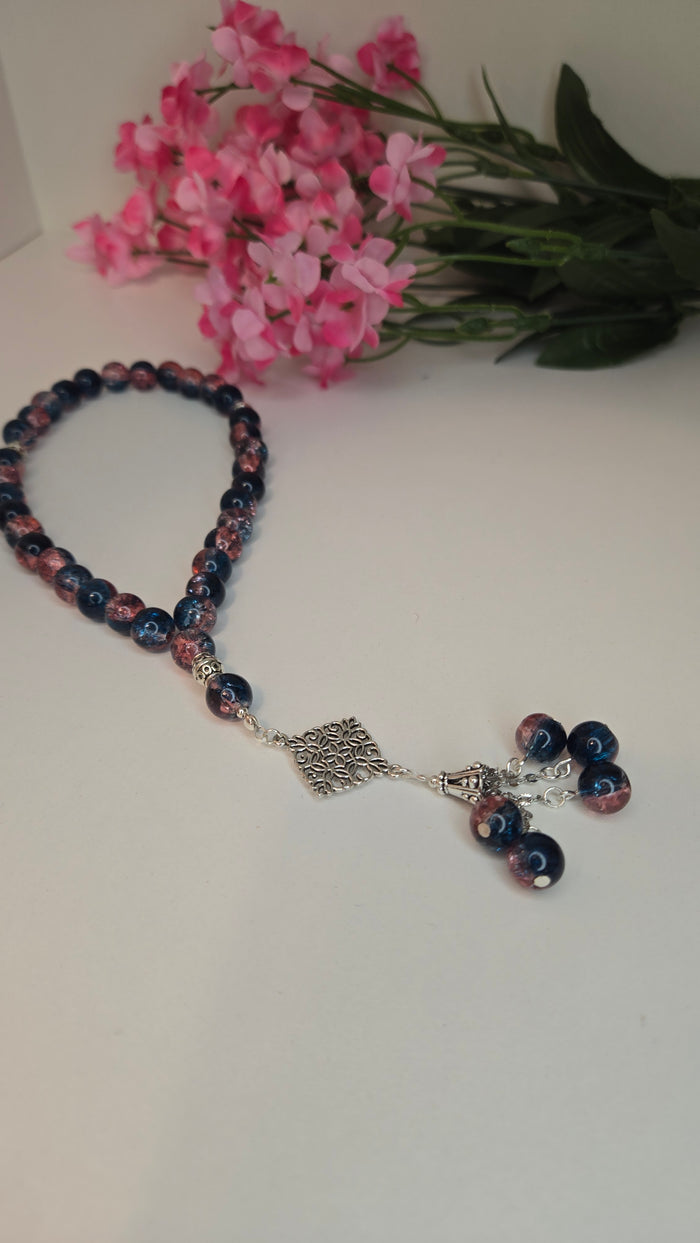 Midnight Bloom Prayer Beads with blue and rose marbled beads and an ornate charm