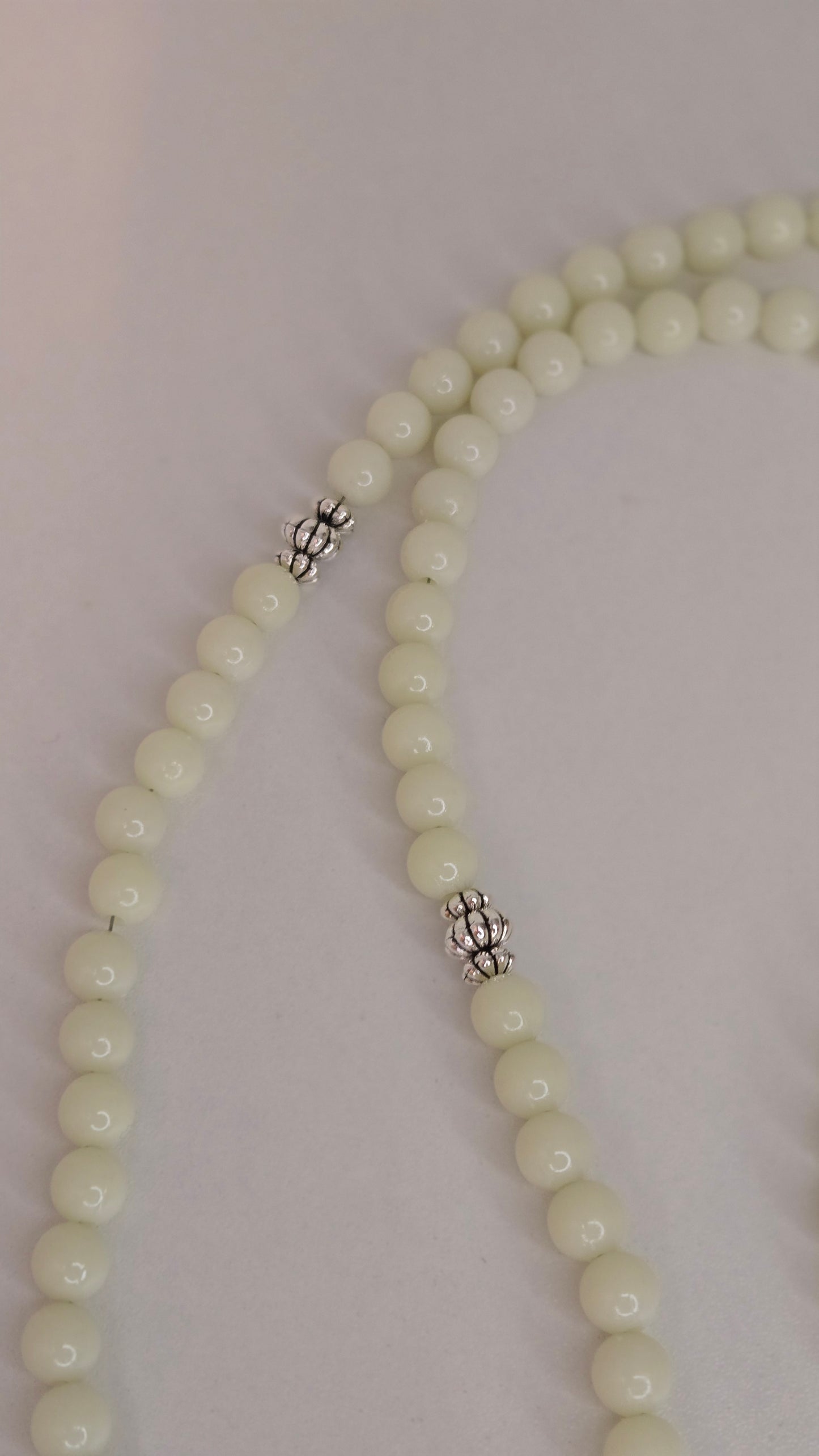 Lifestyle image of Luminous Glow Prayer Beads in use.