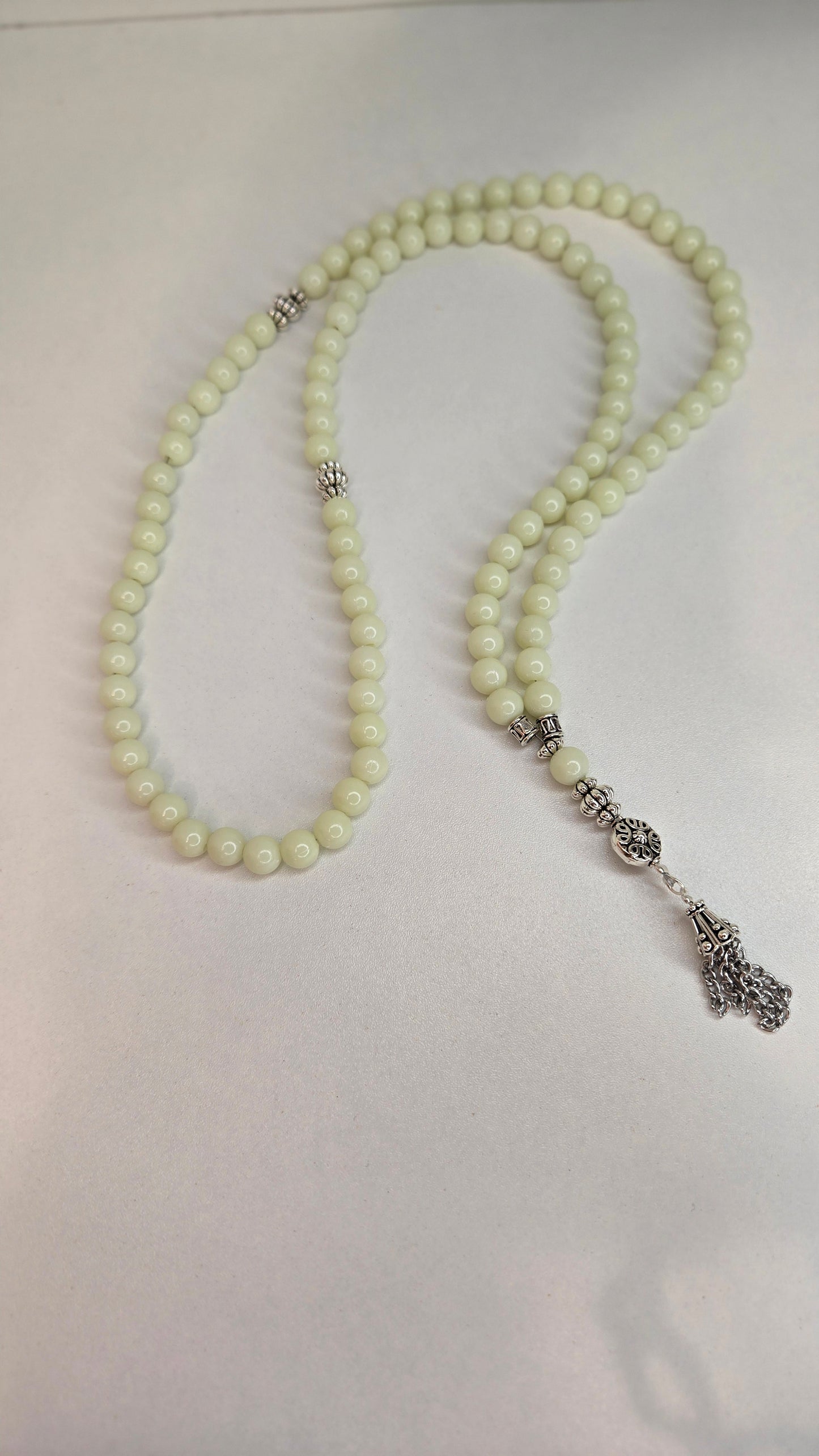 Artistic shot of Luminous Glow Prayer Beads in a yoga setting.