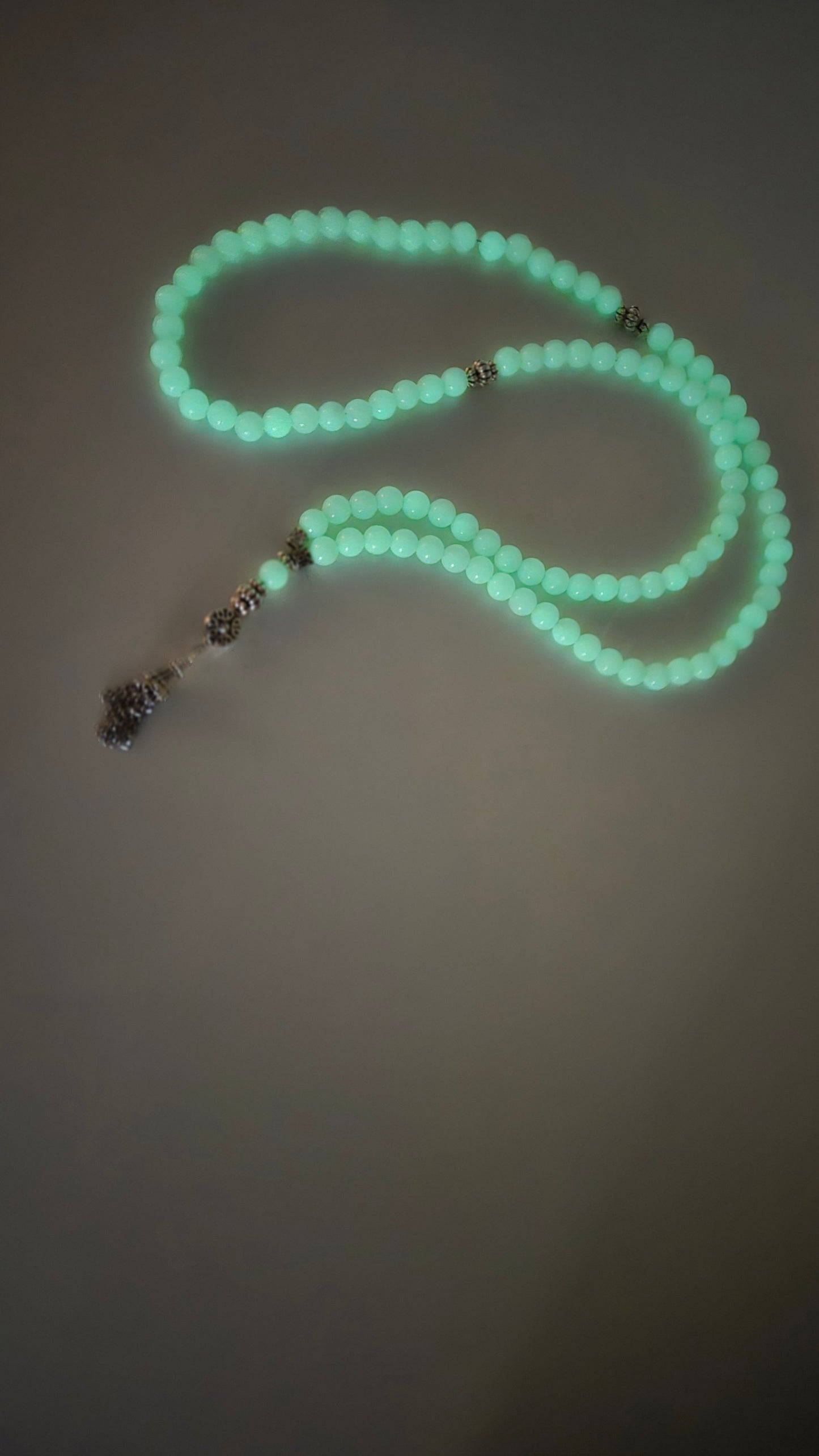Luminous Glow Prayer Beads wrapped around a hand.