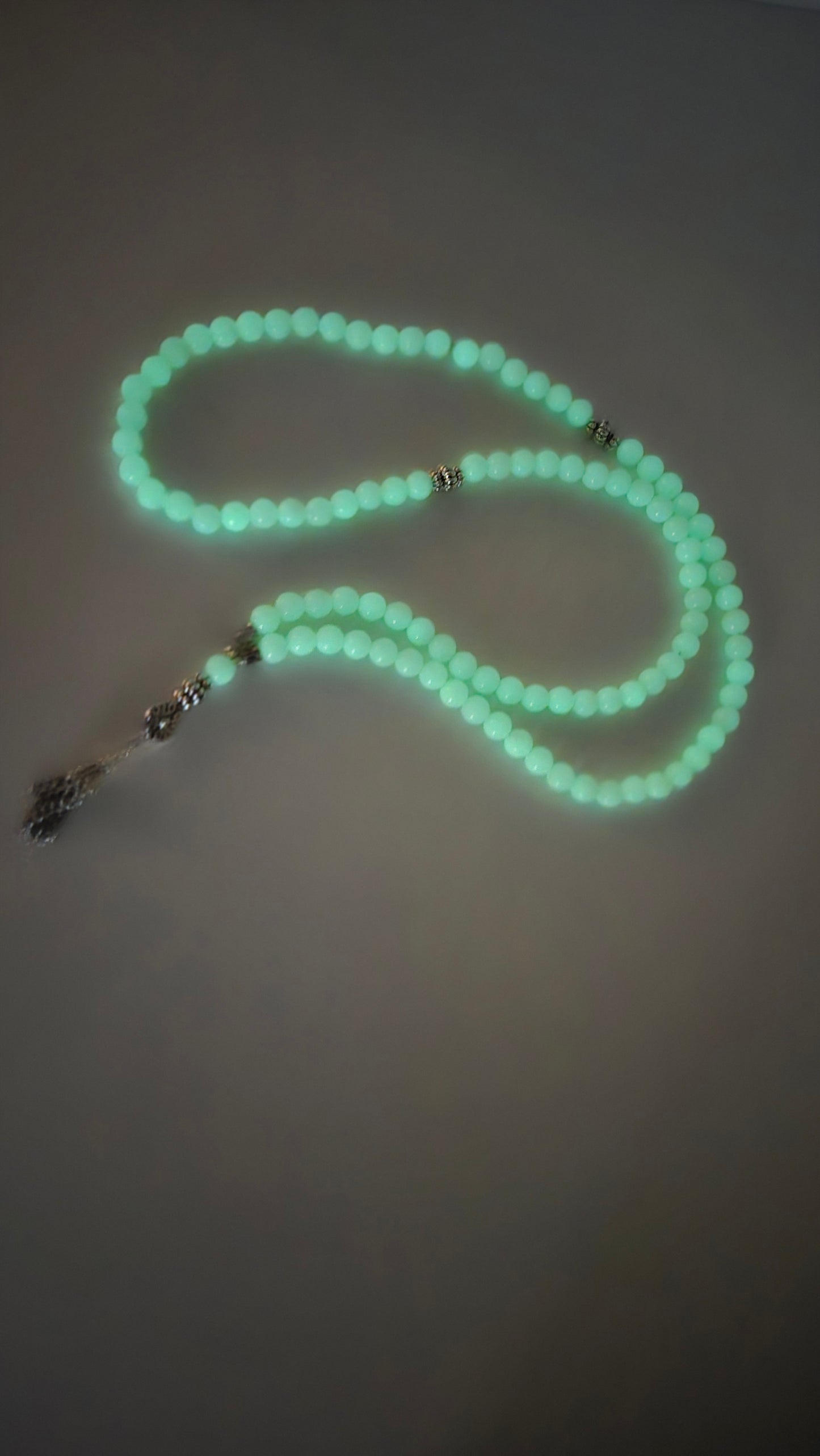 Prayer beads glowing softly with evening light.