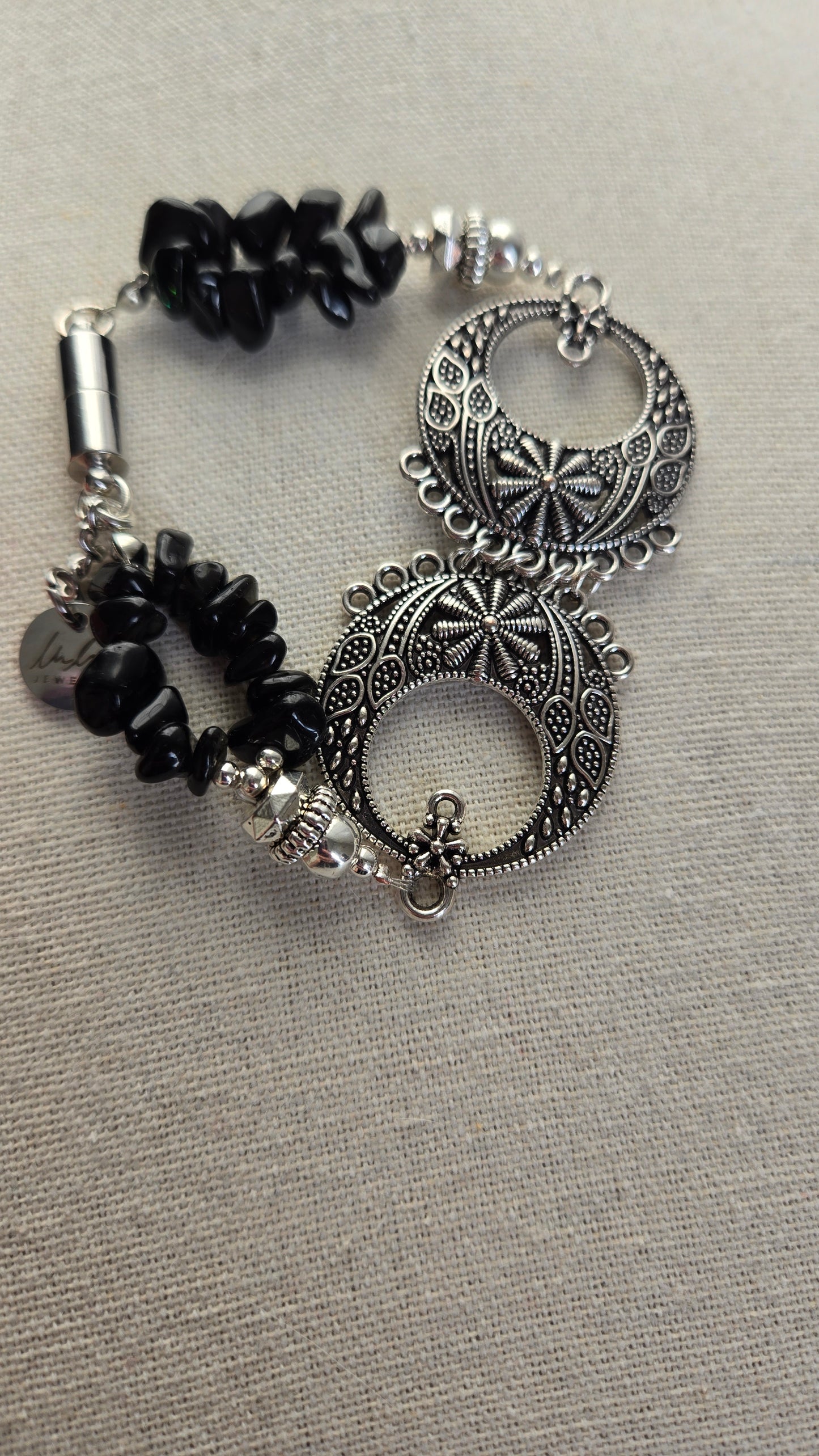 Close-up of Black Moon Bracelet showing black beads and decorative design.