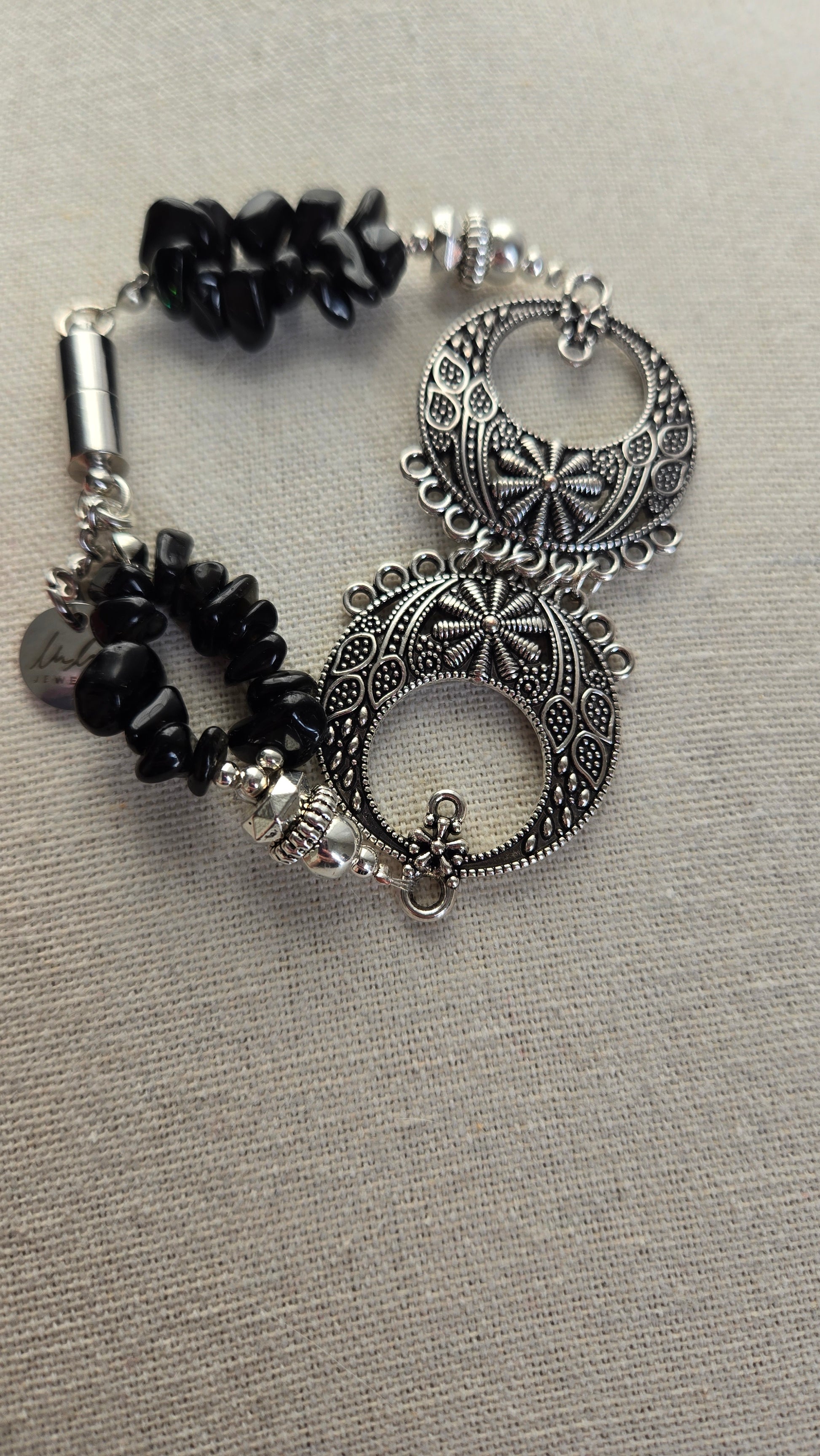 Close-up of Black Moon Bracelet showing black beads and decorative design.
