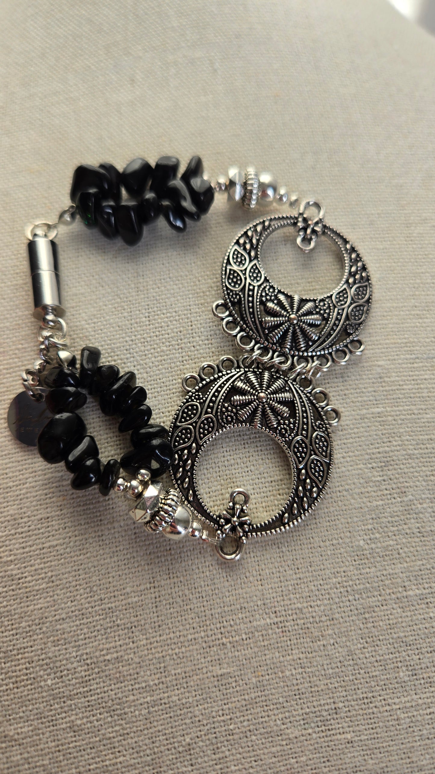Handmade Black Moon Bracelet featuring its unique decorative accents.