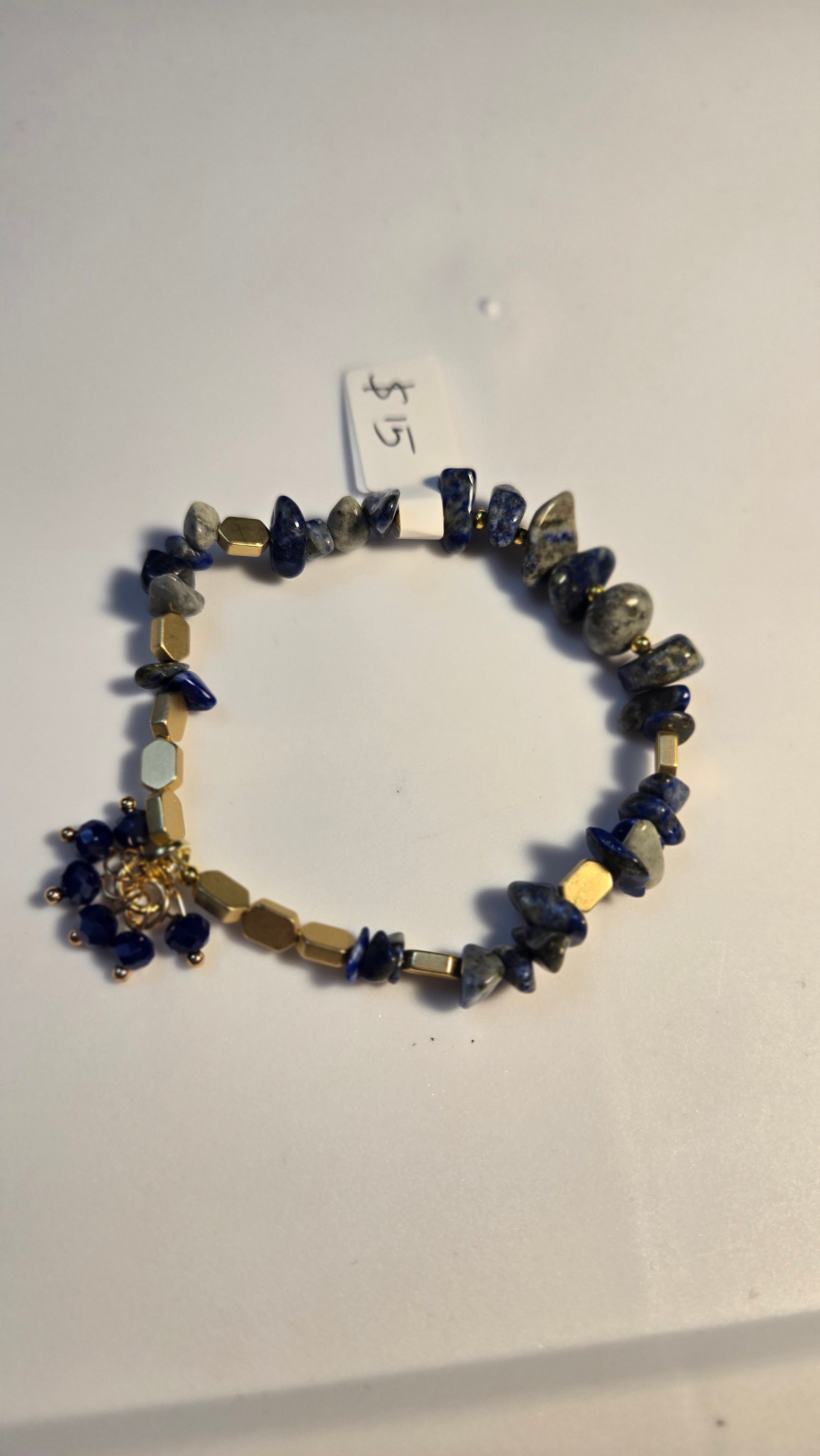 Hand holding the unique Blue Serenity Handmade Bracelet, perfect as a thoughtful gift for women.