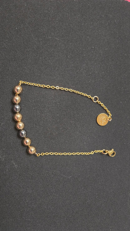 Mixed-Tone Bracelet with gold-tone chain, metallic beads and a round charm