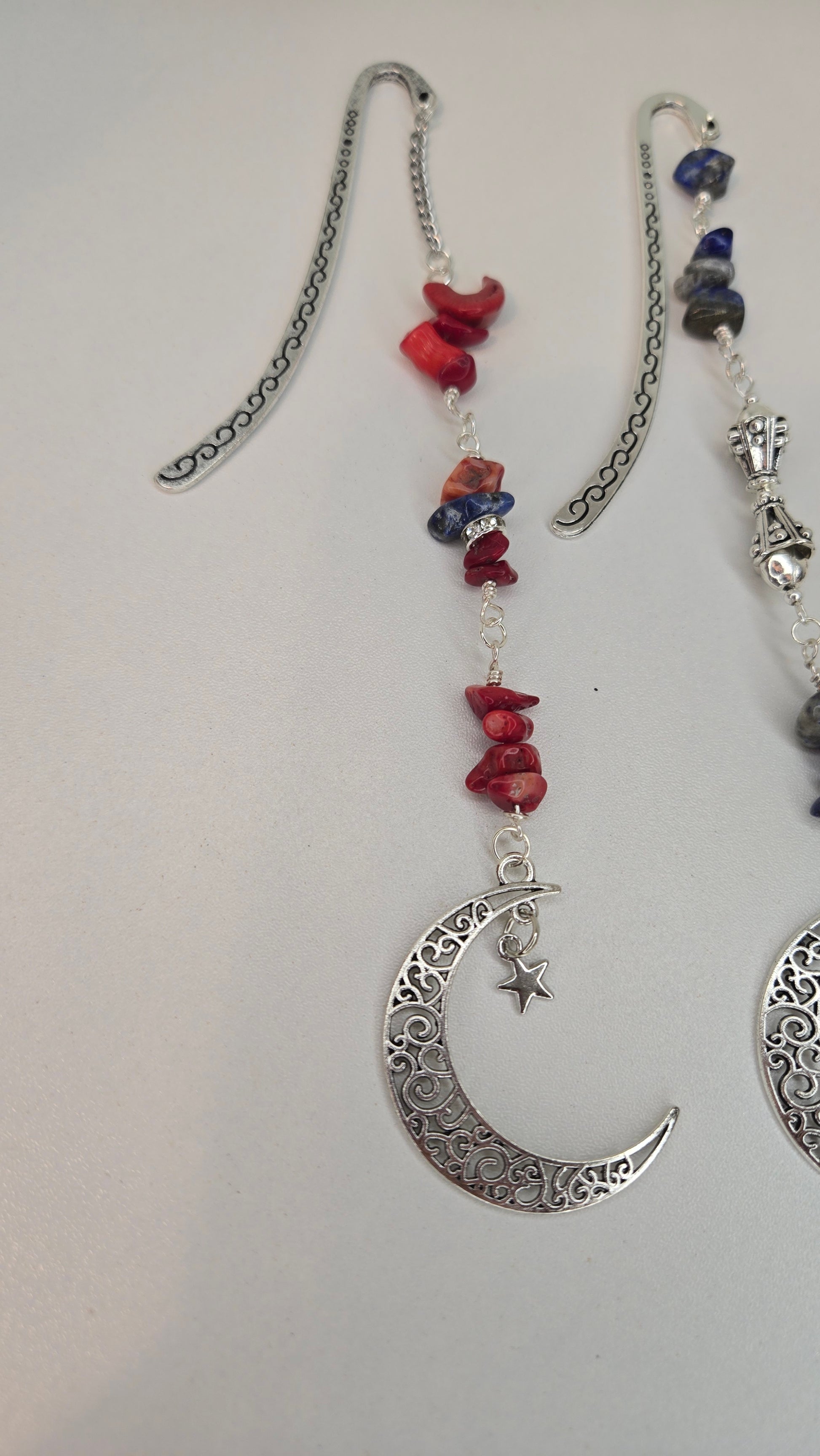 Artistic display of Lapis & Coral Moon pendant surrounded by natural light