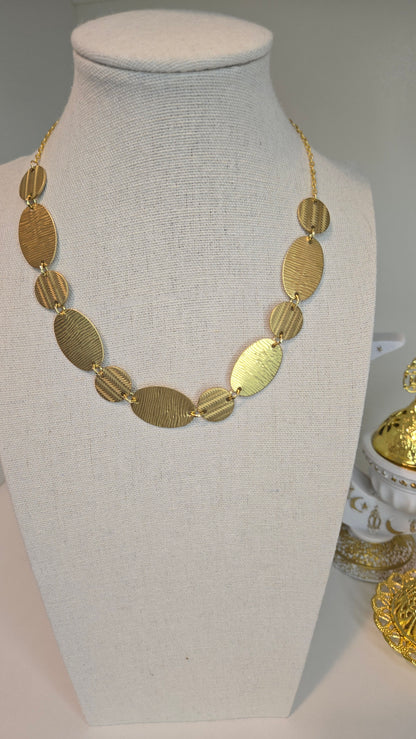 Golden Imprint Engraved Disc Necklace with an oval disc pendant on a gold-tone chain