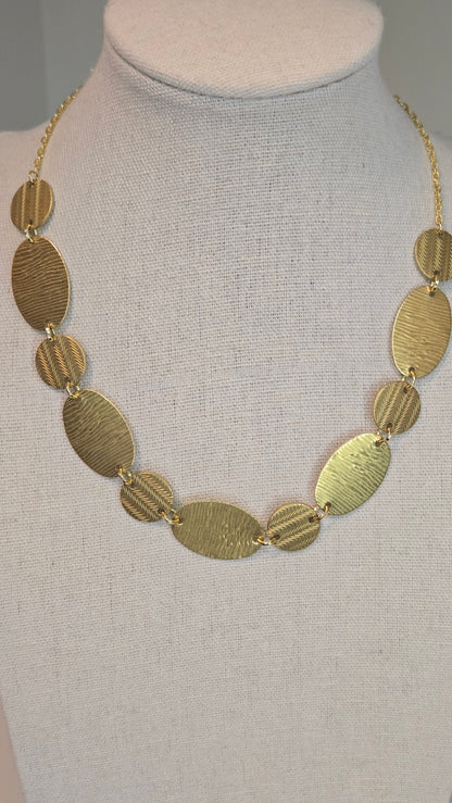 Golden Imprint Engraved Disc Necklace with an oval disc pendant on a gold-tone chain, view 2