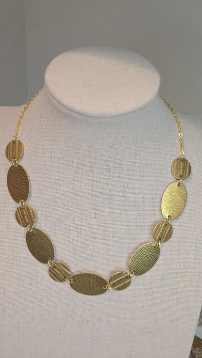 Golden Imprint Engraved Disc Necklace with an oval disc pendant on a gold-tone chain, view 3