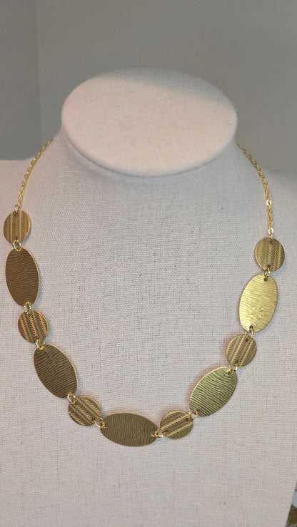 Golden Imprint Engraved Disc Necklace with an oval disc pendant on a gold-tone chain, view 4