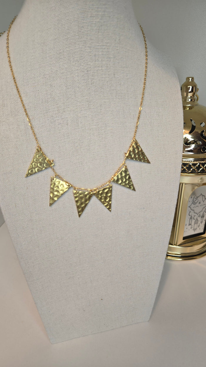 Golden Flames Necklace with hammered gold-plated triangle pendants on a chain