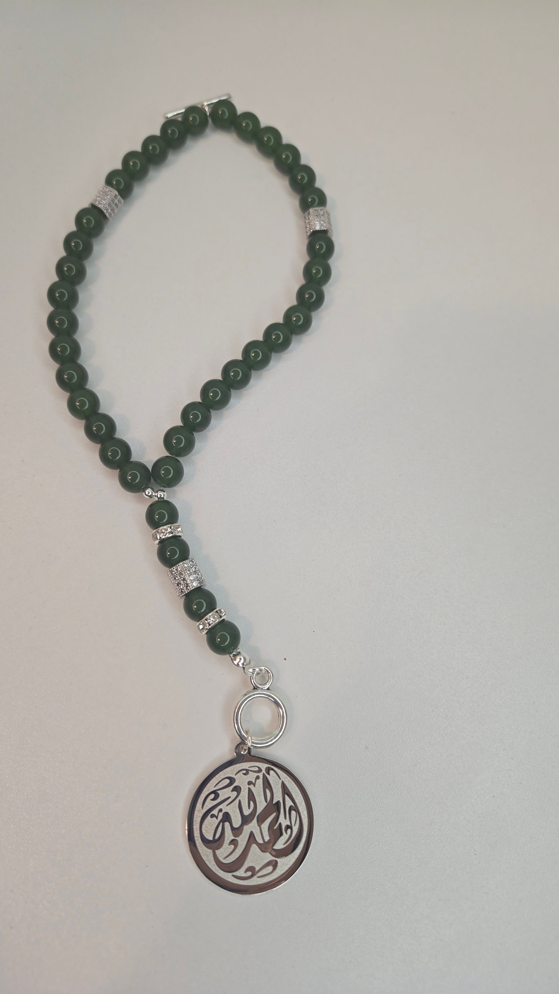 Blue Tiger Eye Tasbih elegantly draped on a prayer mat, highlighting its use for Islamic prayer and spiritual devotion.