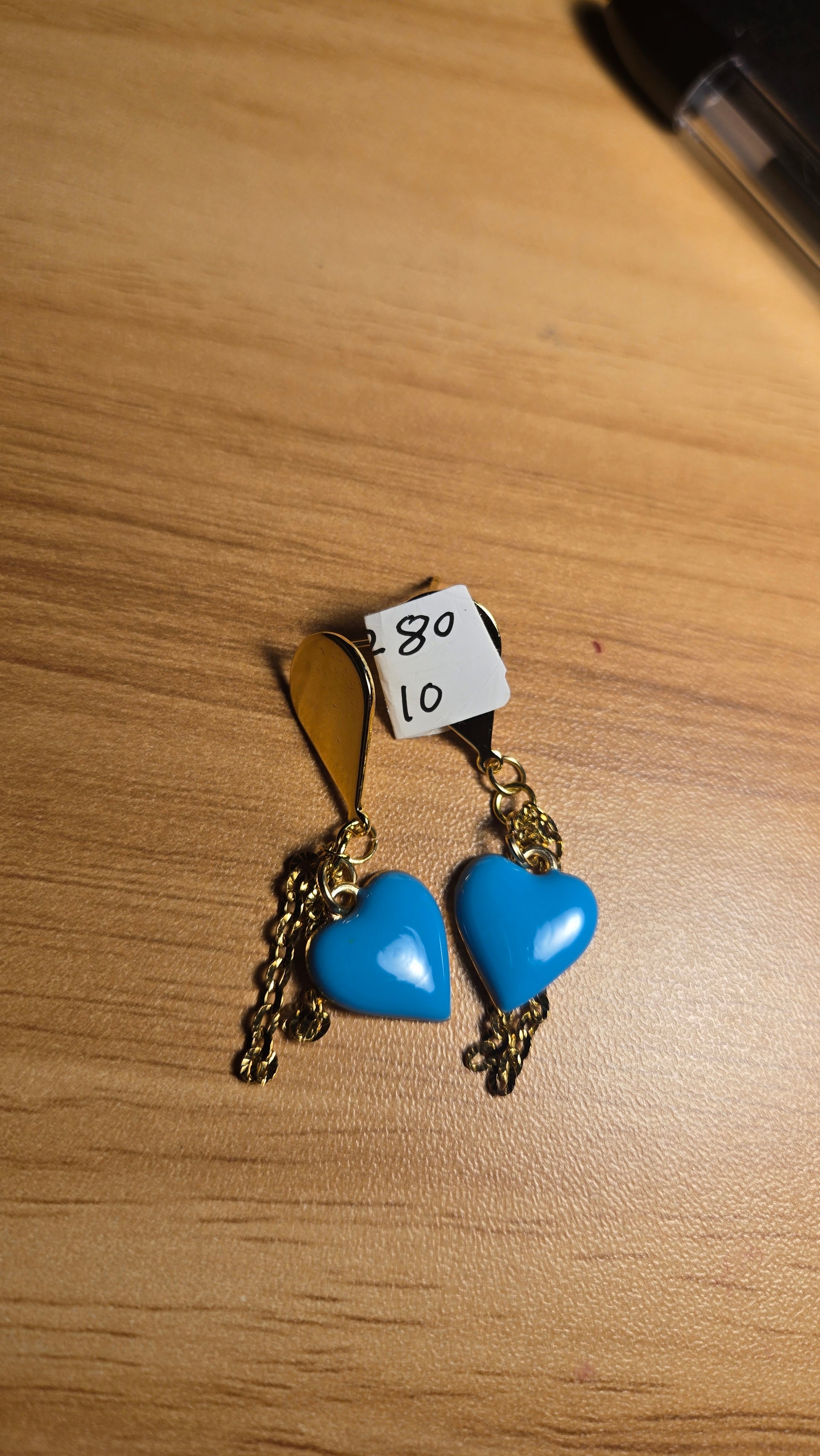 Graceful woman wearing Ocean Heart handmade blue heart dangle earrings