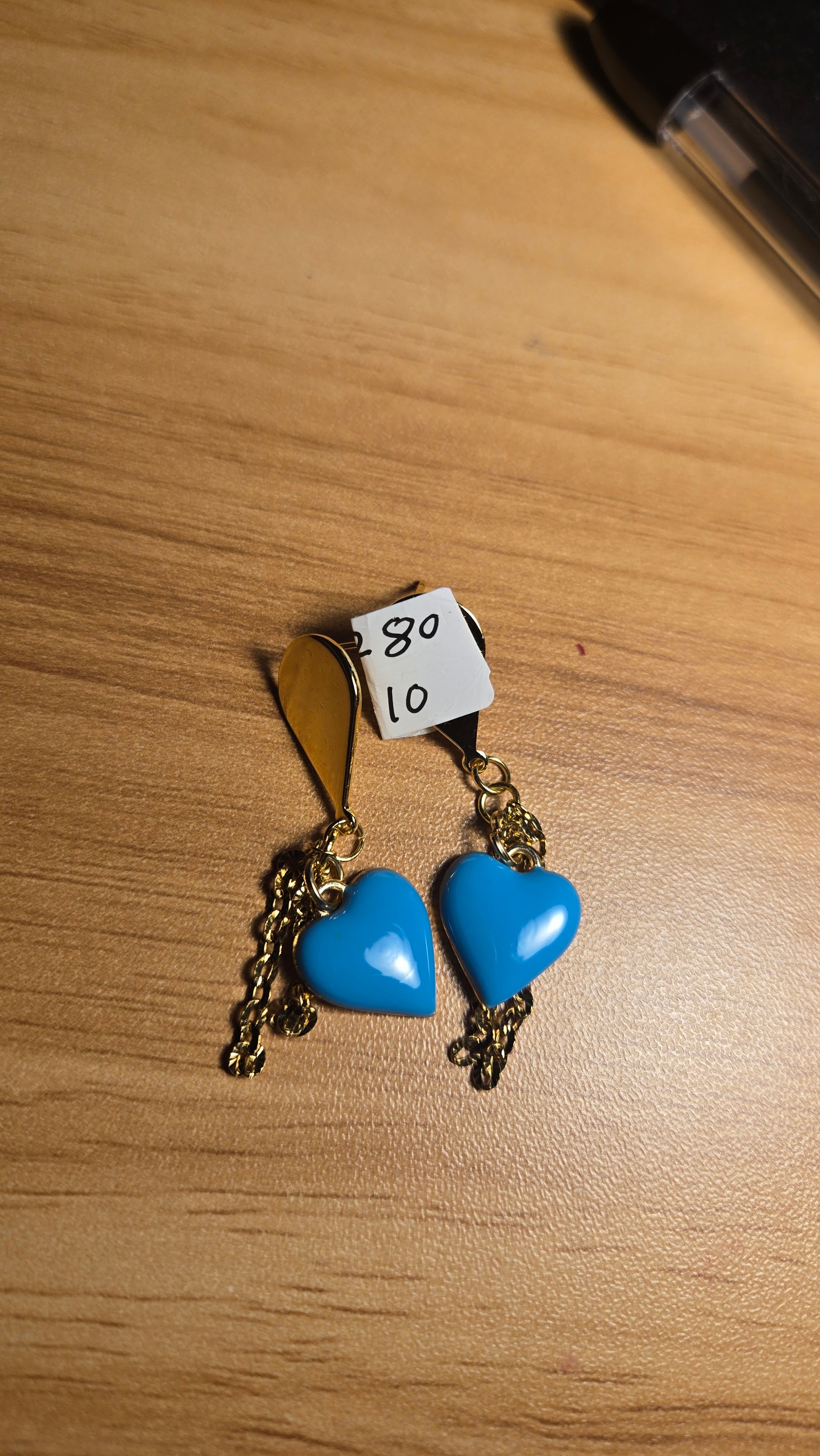 Close-up of elegant Ocean Heart blue heart pendants on artisan earrings