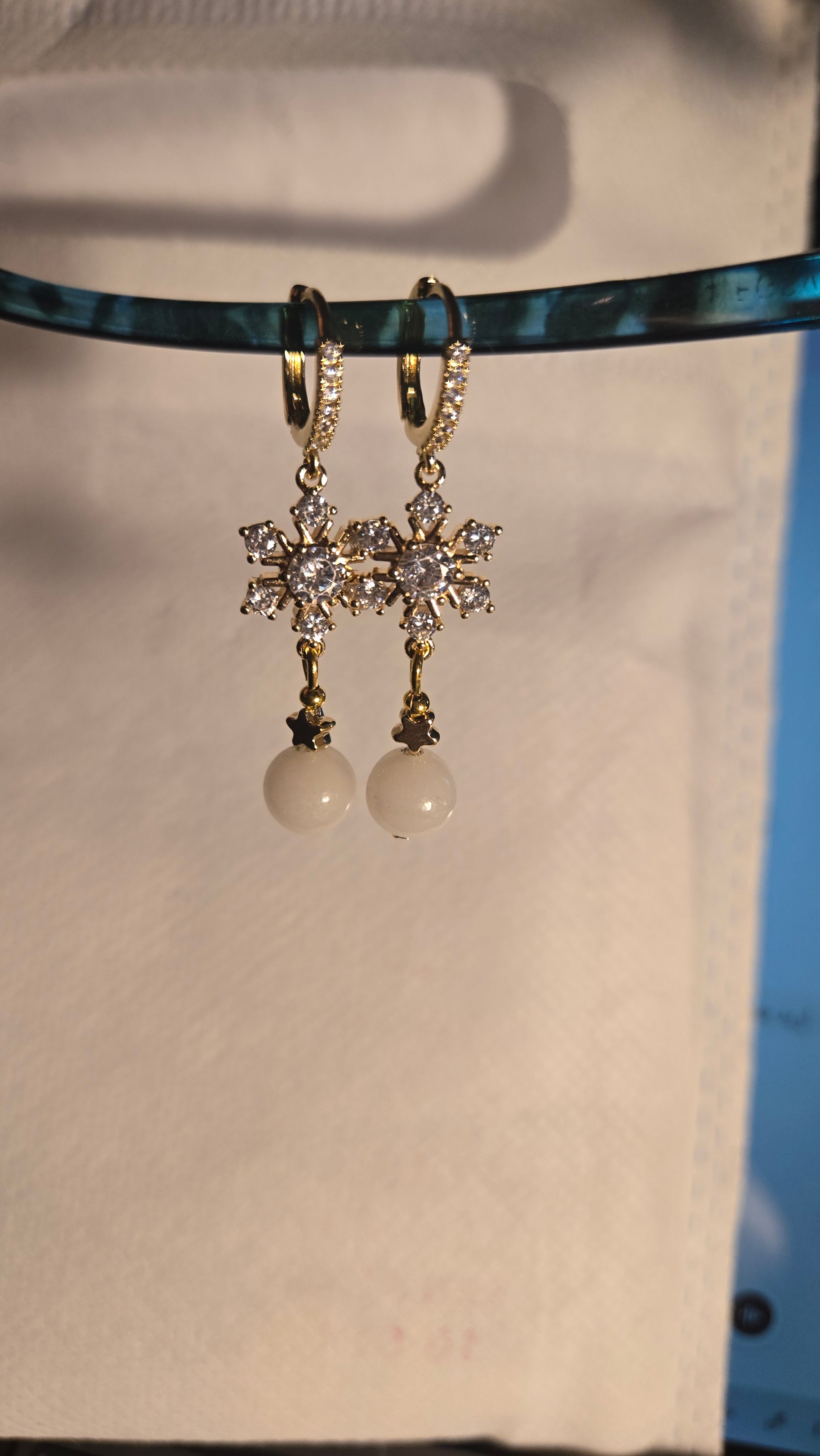 Model wearing Celestial Pearl Star Earrings, showcasing their delicate dangle and shine