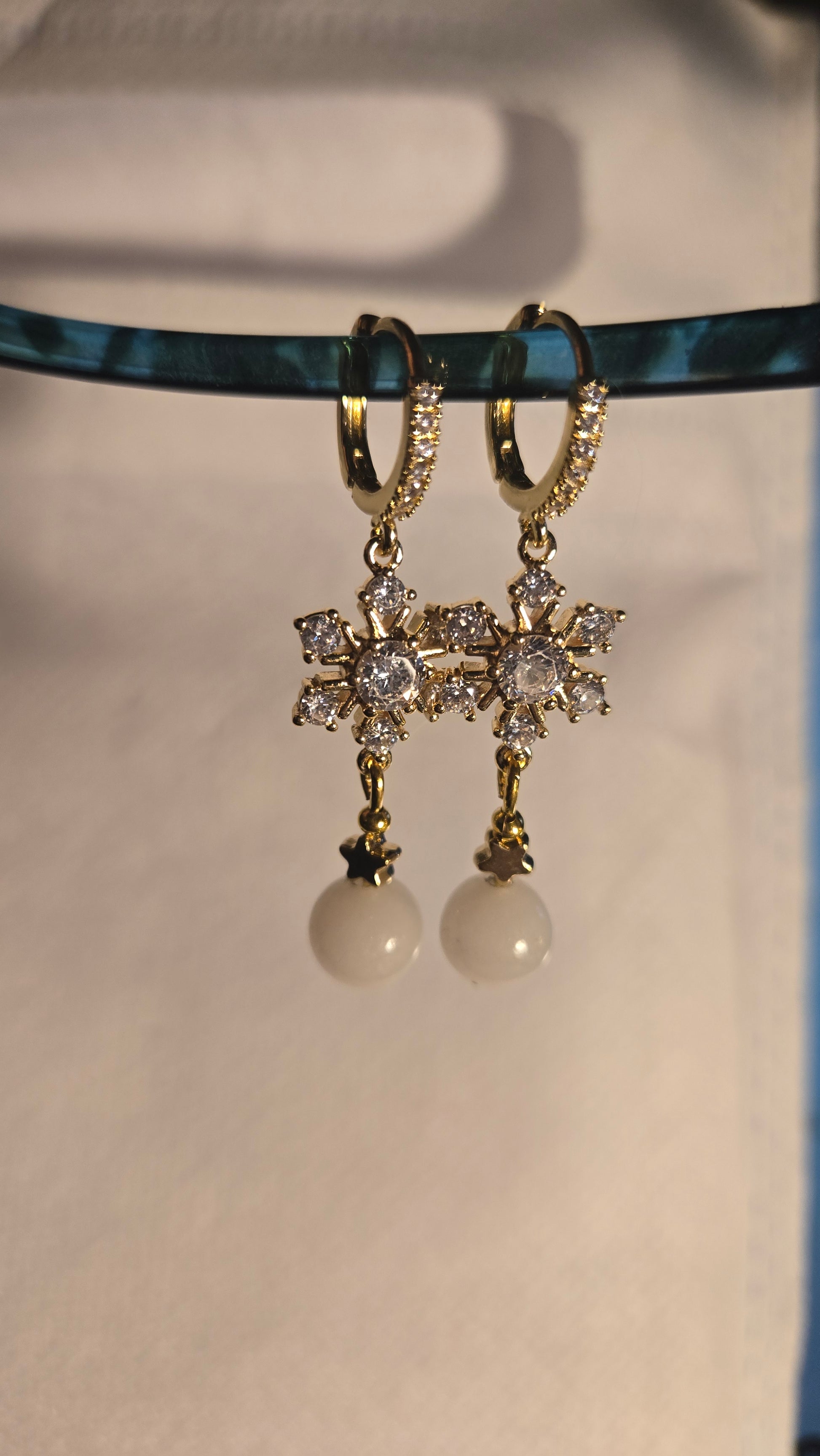 Pair of Celestial Pearl Star Earrings displayed from a different angle, showing craftsmanship