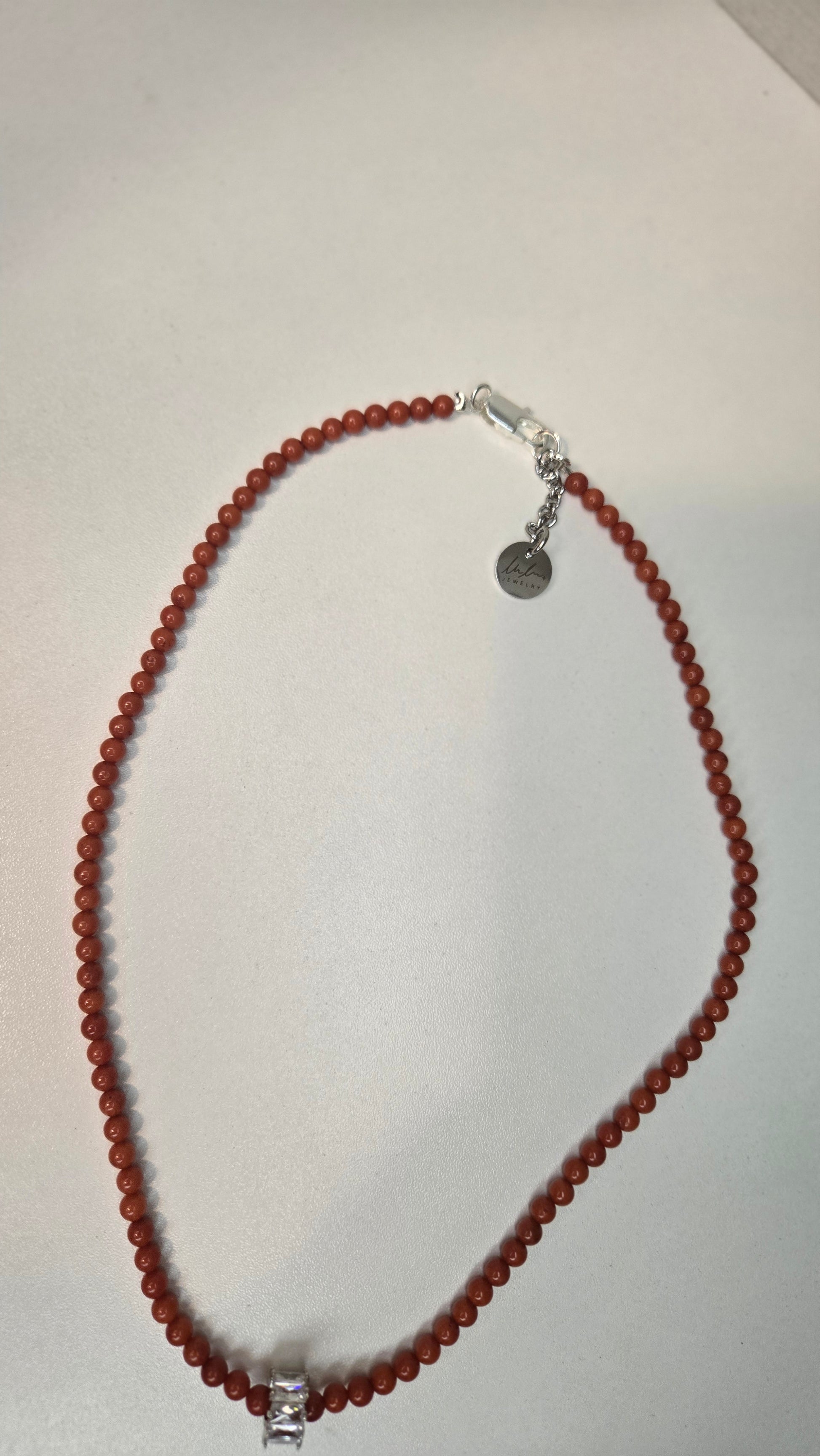 Detail shot of the gold clasp and natural tiger eye stone patterns on the bracelet.