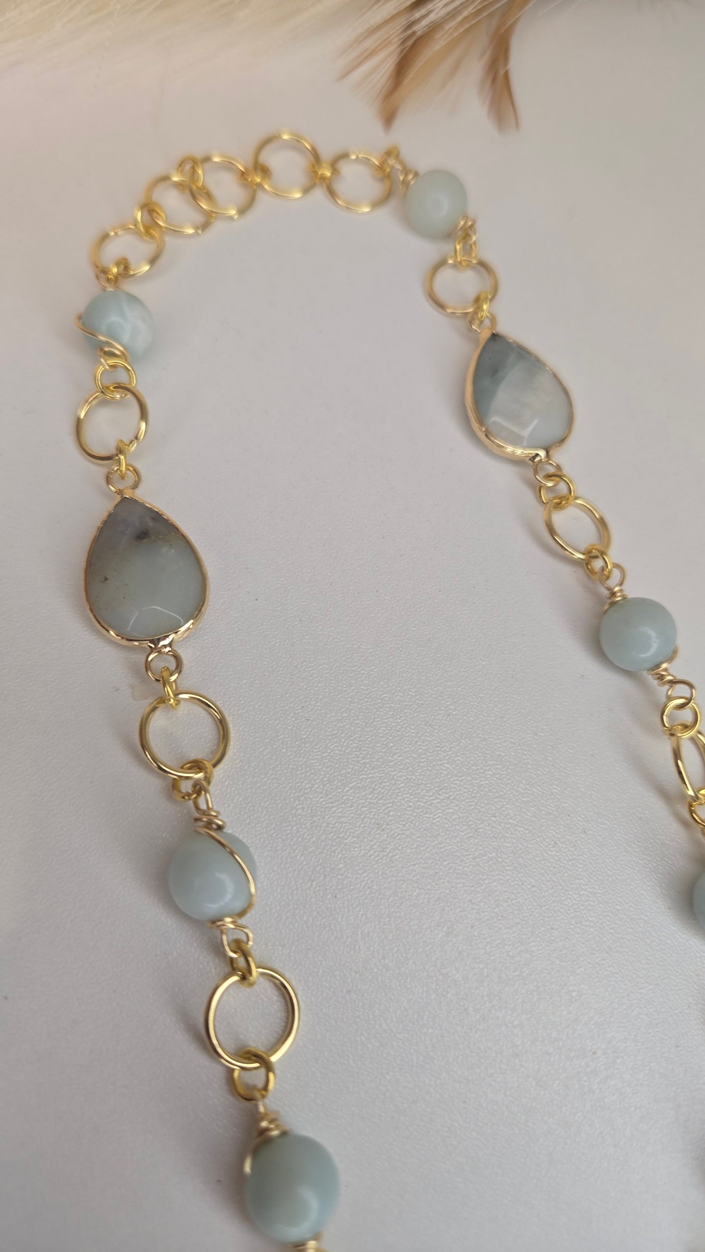 The Amazonite & Agate Necklace displayed on a velvet stand, emphasizing its luxurious presentation and craftsmanship.