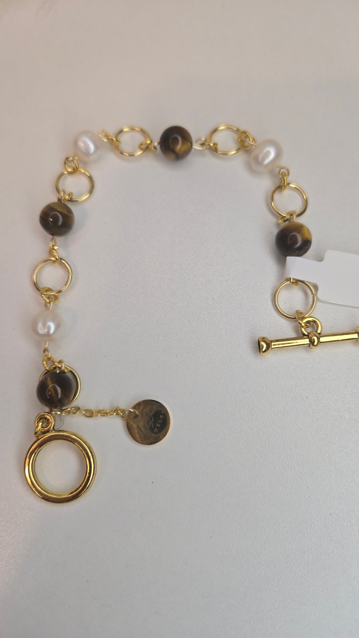 Hand holding Royal Tiger Eye Bracelet showing its texture and quality