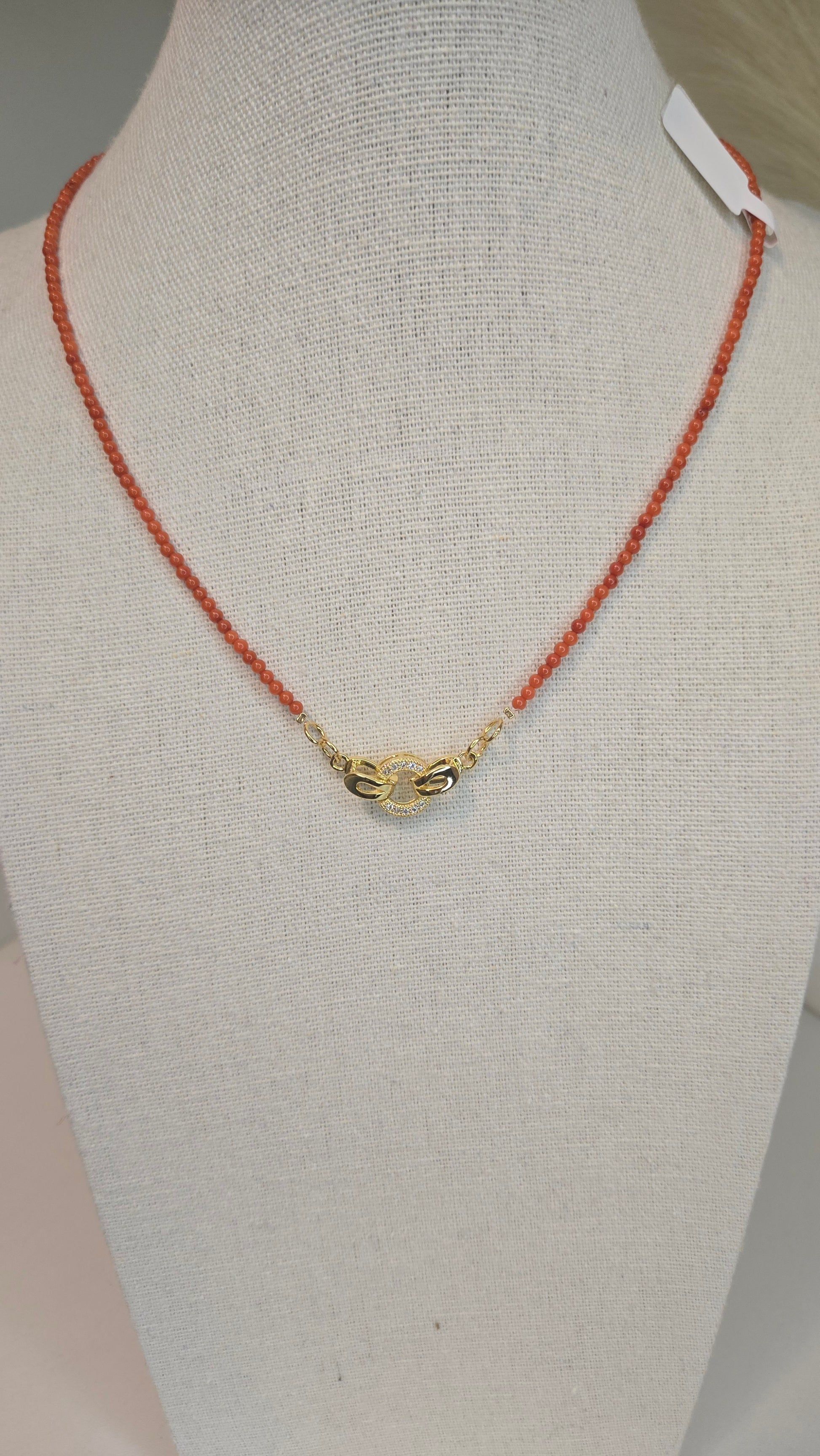 LuluTouch Coral Whisper Necklace featuring delicate coral beads and sparkling gold centerpiece