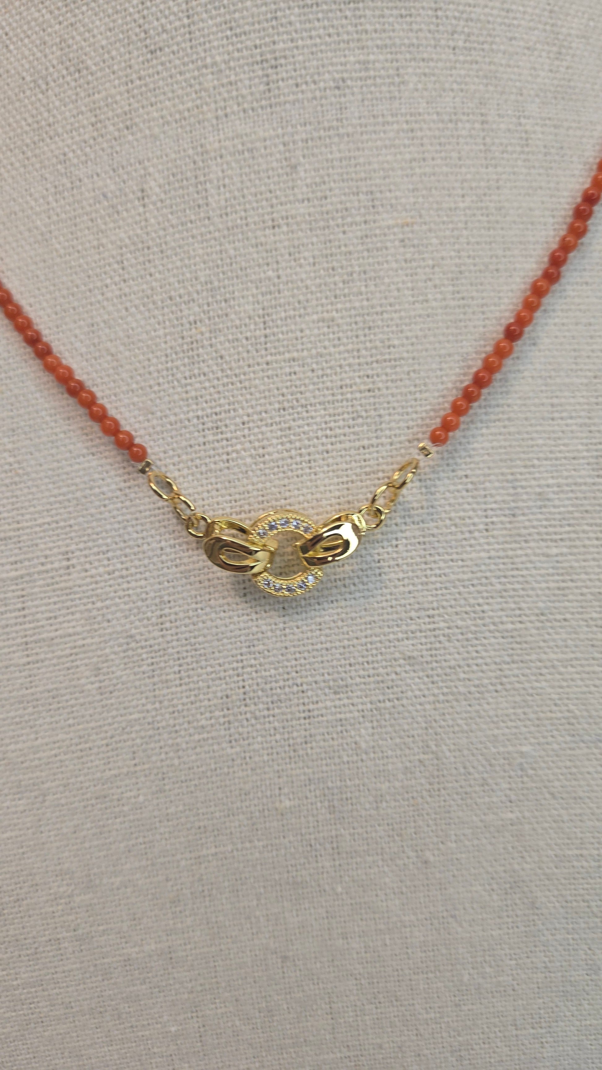 Elegant woman wearing Coral Whisper Necklace, highlighting its feminine touch