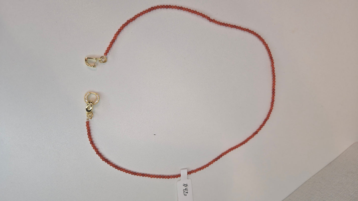 Detail shot of the Coral Whisper Necklace clasp and adjustable chain