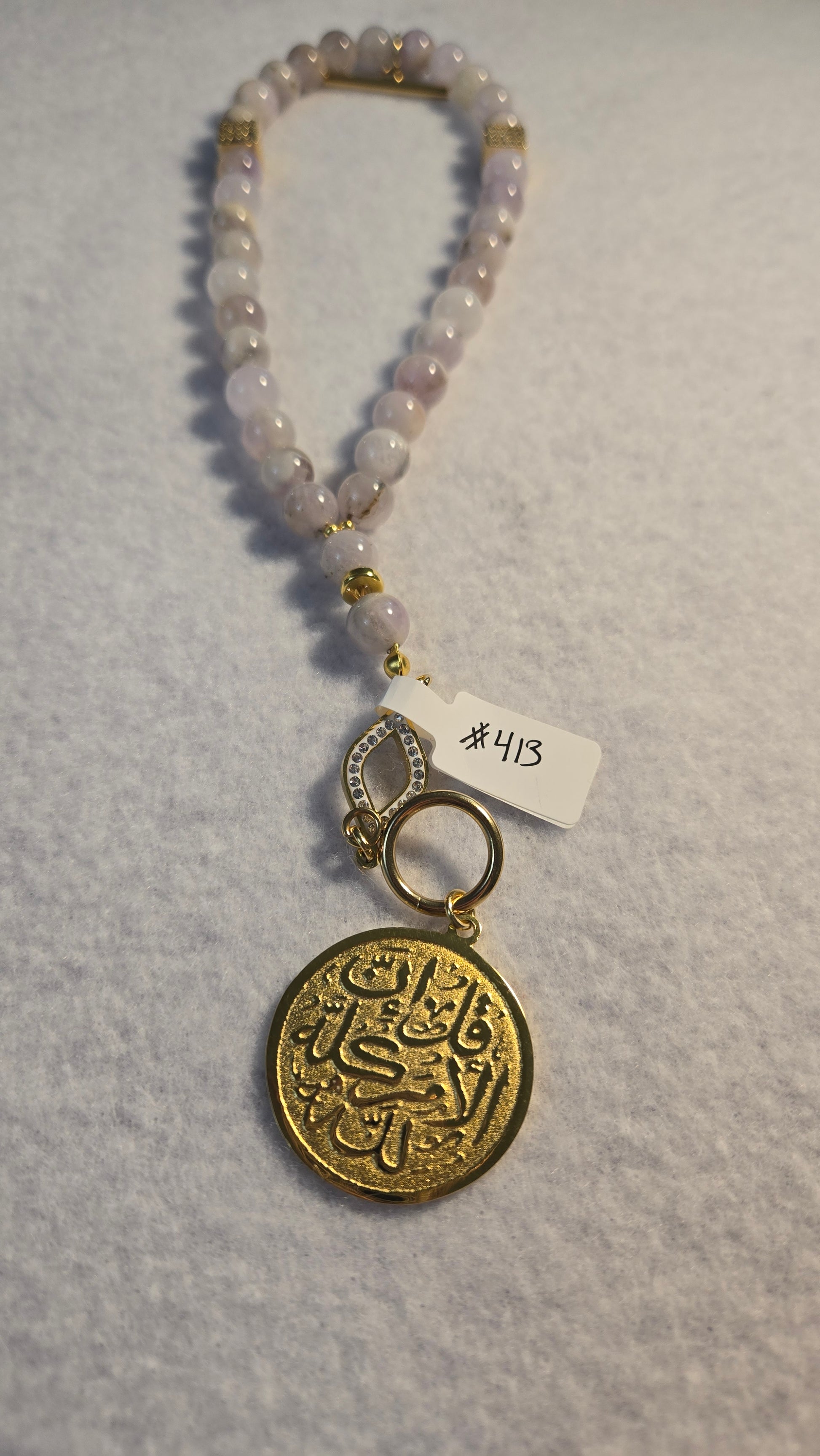 Elegant Amethyst prayer beads tasbih featuring a decorative Arabic medallion