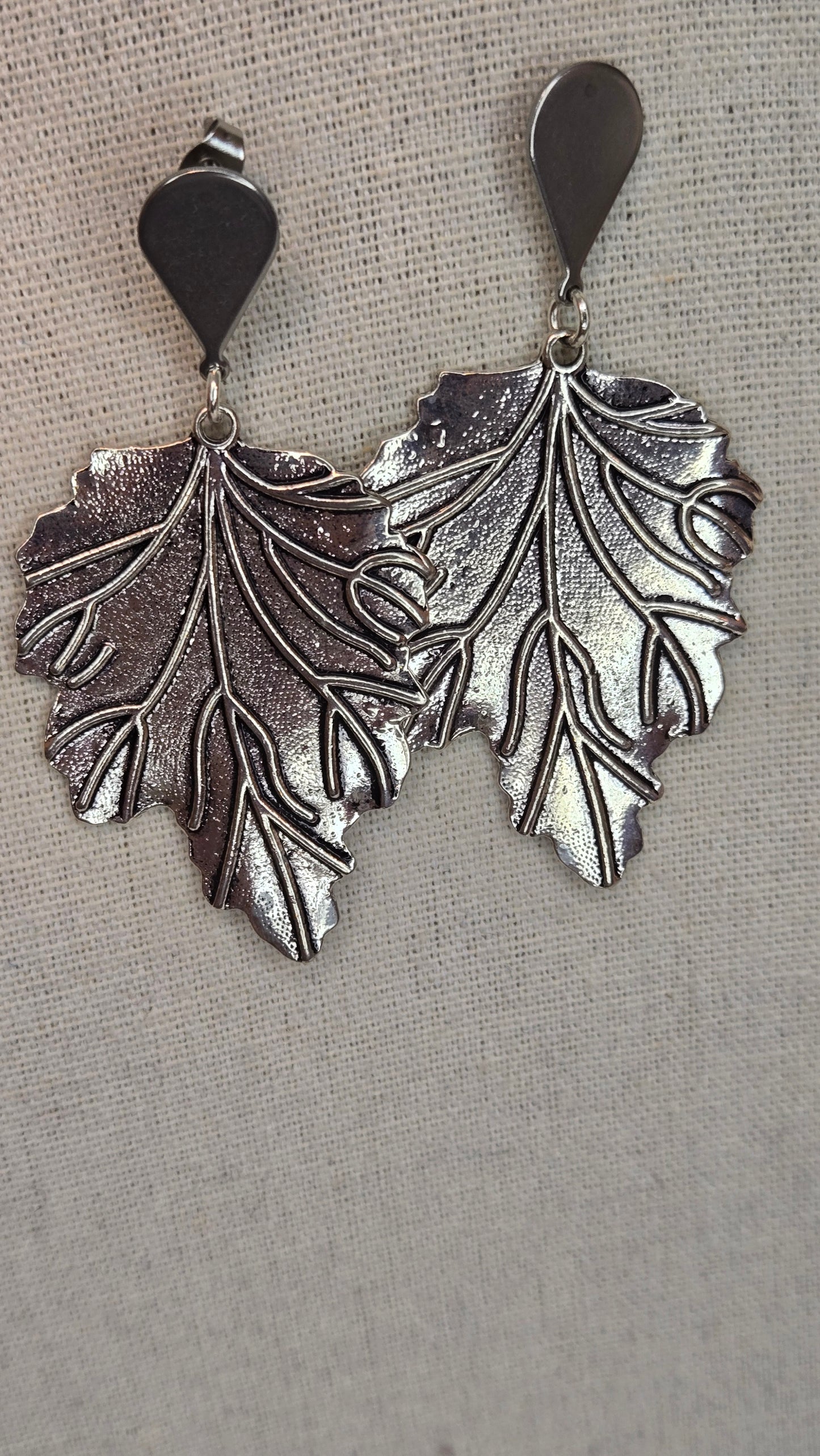 Elegant silver leaf earrings on display