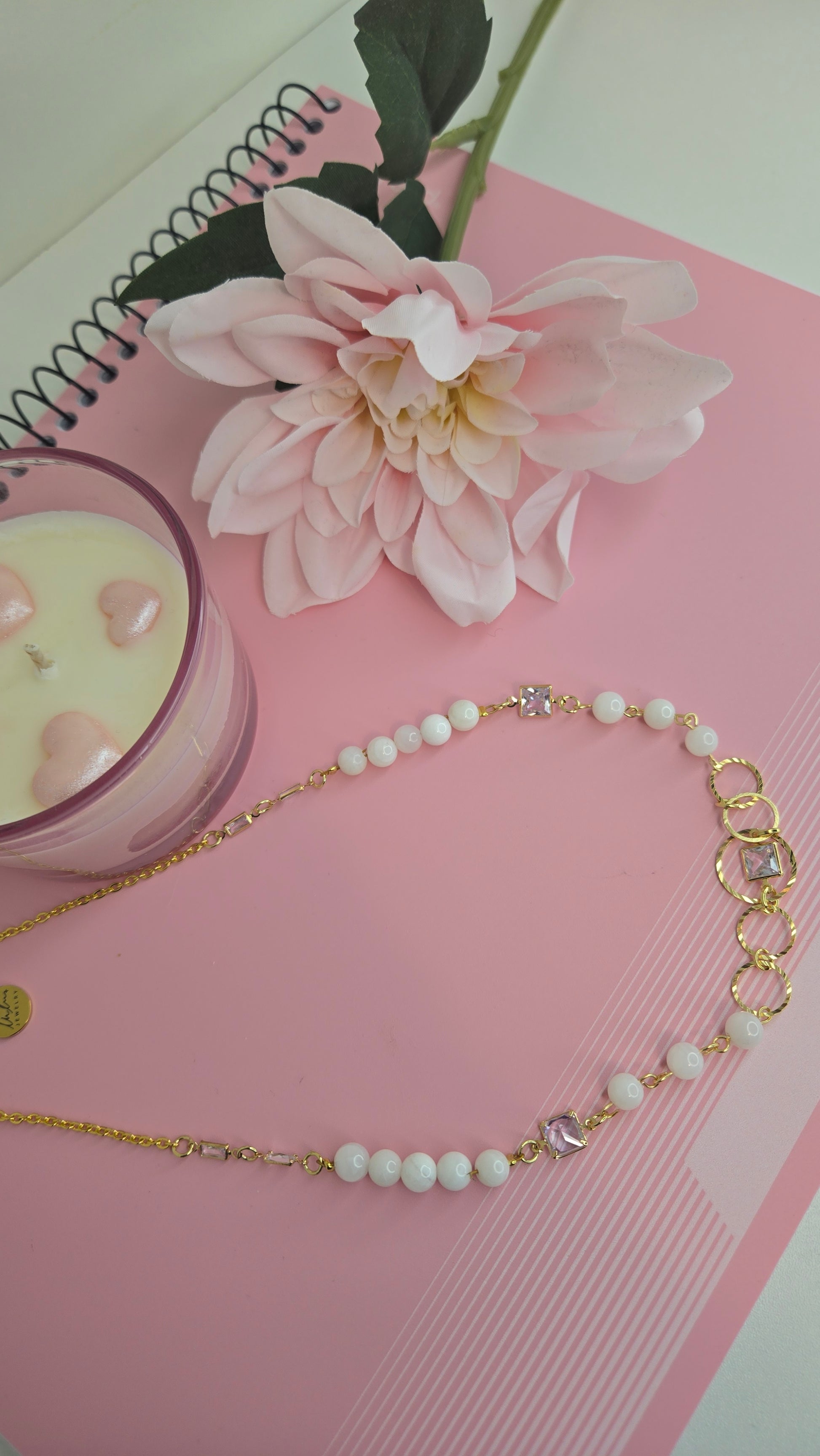 Hand holding the handmade Dream Pearl Necklace, showing scale and artisanal quality