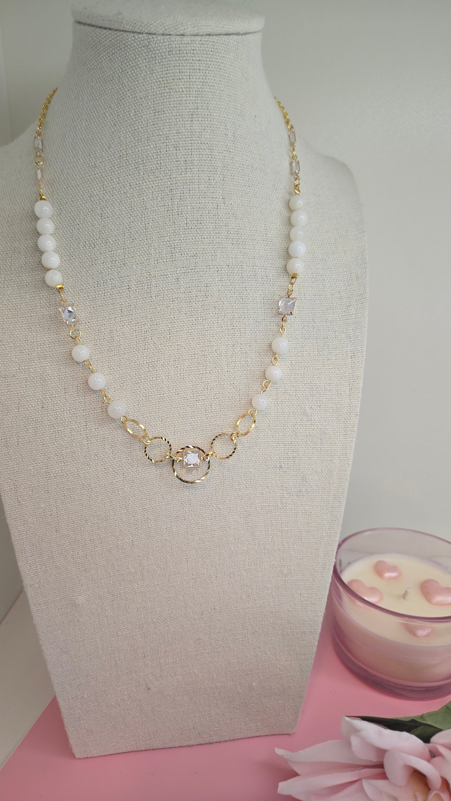 Elegant flat lay of the Dream Pearl Necklace with a small flower and gift box